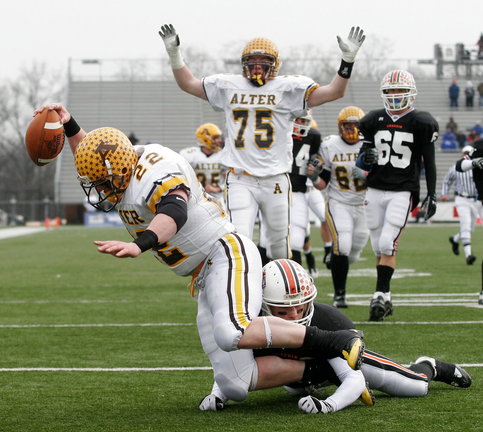 Alter's Cody Taulbee scores one of his three touchdowns of the day as teammate Joe Thuney (75) celebrates. The Alter High School football team won its second consecutive Division IV state football championship with a 37-7 win over Chagrin Falls on Saturday, Dec. 5, at Fawcett Stadium.