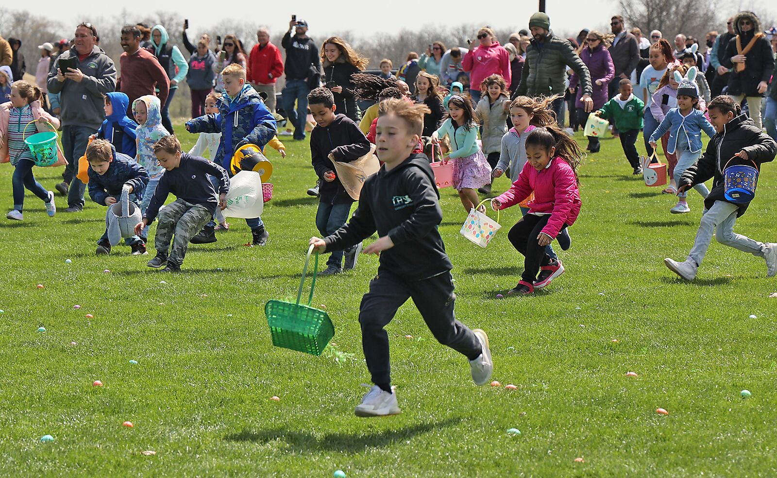 Hundreds of children race across the driving range at Young's Jersey Dairy picking up dyed hard boiled eggs during the annual Easter egg hunt IN 2022. BILL LACKEY/STAFF