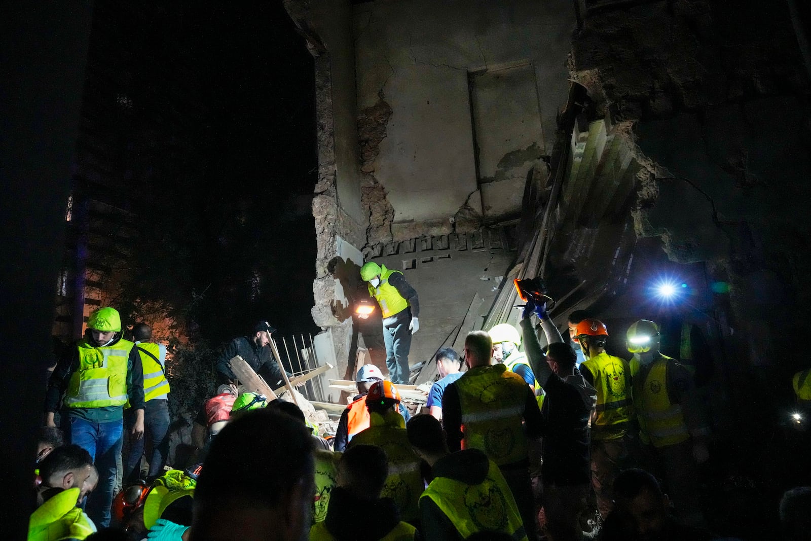 Rescue workers search for victims at the site of an Israeli airstrike in Beirut, Lebanon, Monday, Nov. 18, 2024. (AP Photo/Hussein Malla)