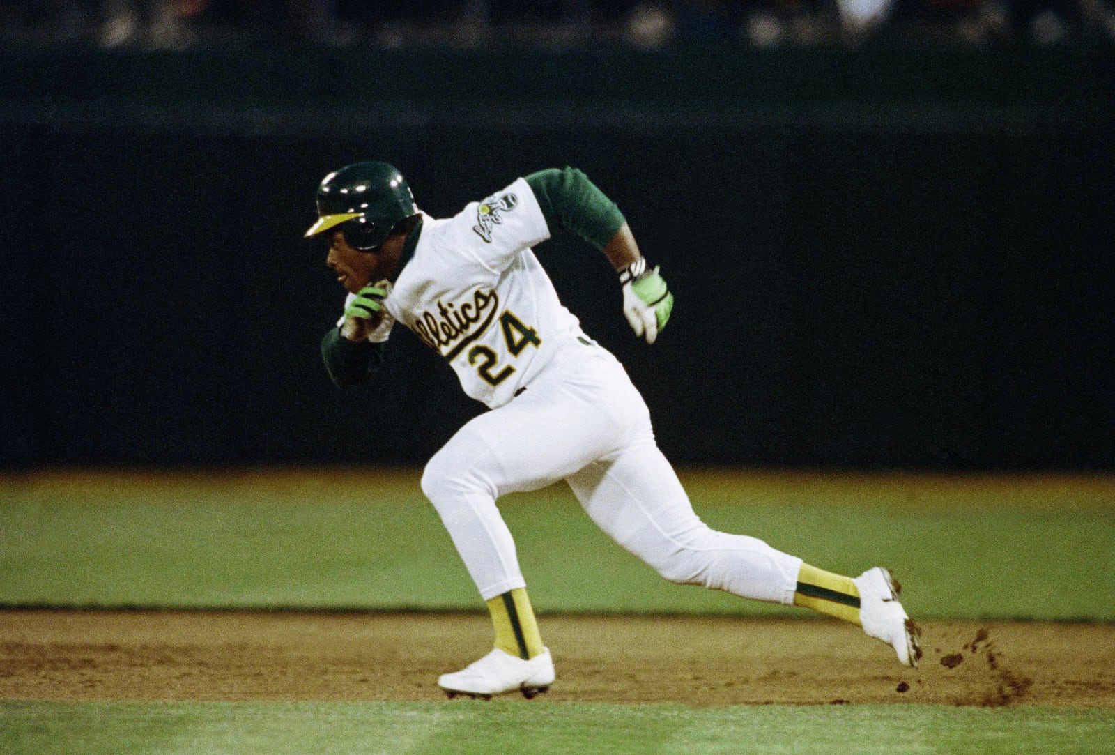 FILE - Oakland Athletics' Rickey Henderson steals second base against the Minnesota Twins in the first inning of a baseball game at Oakland Coliseum in Oakland, Calif., April 10, 1991. (AP Photo/Alan Greth, File)