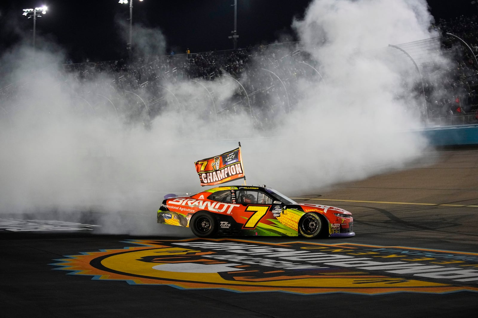 Justin Allgaier does a burnout after winning the championship after a NASCAR Xfinity Series auto race, Saturday, Nov. 9, 2024, in Avondale, Ariz. (AP Photo/John Locher)