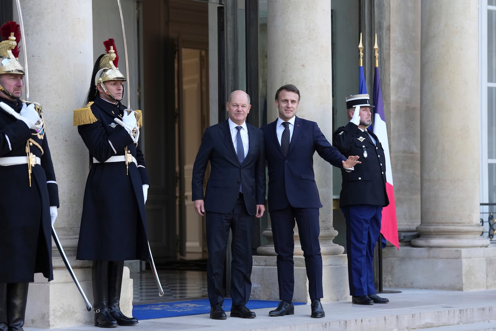 French President Emmanuel Macron, right, greets Germany's Chancellor Olaf Scholz as he arrives for an informal meeting of leaders from key European Union nations and the United Kingdom at the Elysee Palace in Paris, Monday, Feb. 17, 2025. (AP Photo/Aurelien Morissard)