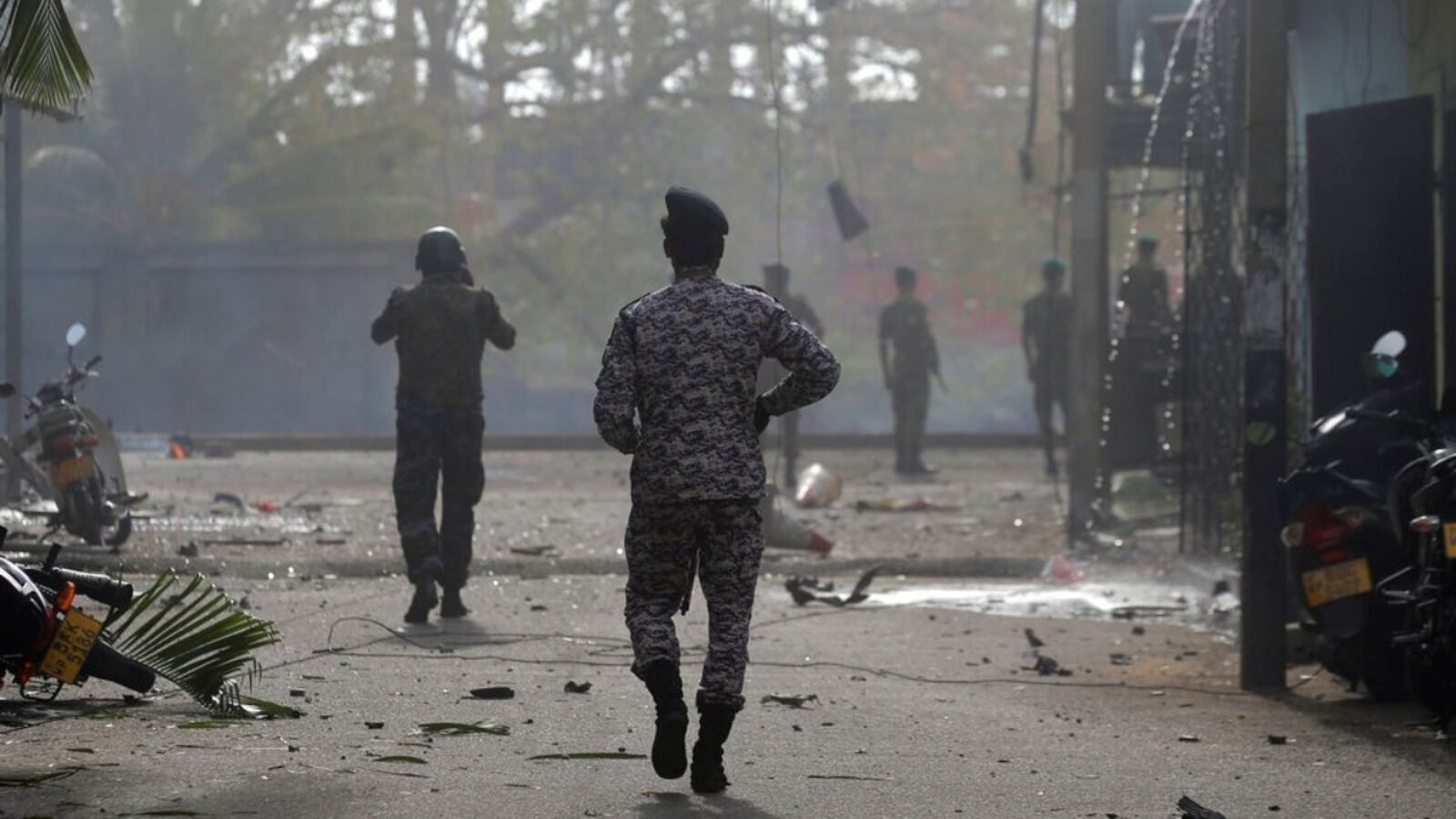 Sri Lankan security forces approach the site after a vehicle parked near St. Anthony's shrine exploded in Colombo, Sri Lanka, Monday, April 22, 2019. Easter Sunday bombings that ripped through churches and luxury hotels killed more than 200 people.