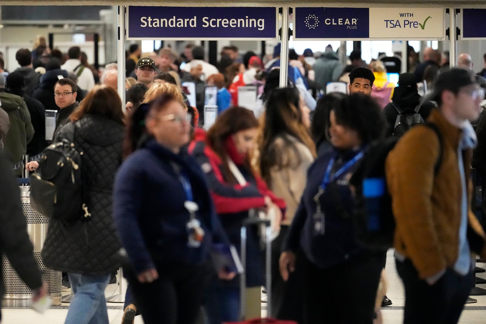 Passengers go through security at George Bush Intercontinental Airport Monday, Jan. 20, 2025, in Houston, ahead of a winter storm that will close both of Houston's airports Tuesday. (AP Photo/David J. Phillip))