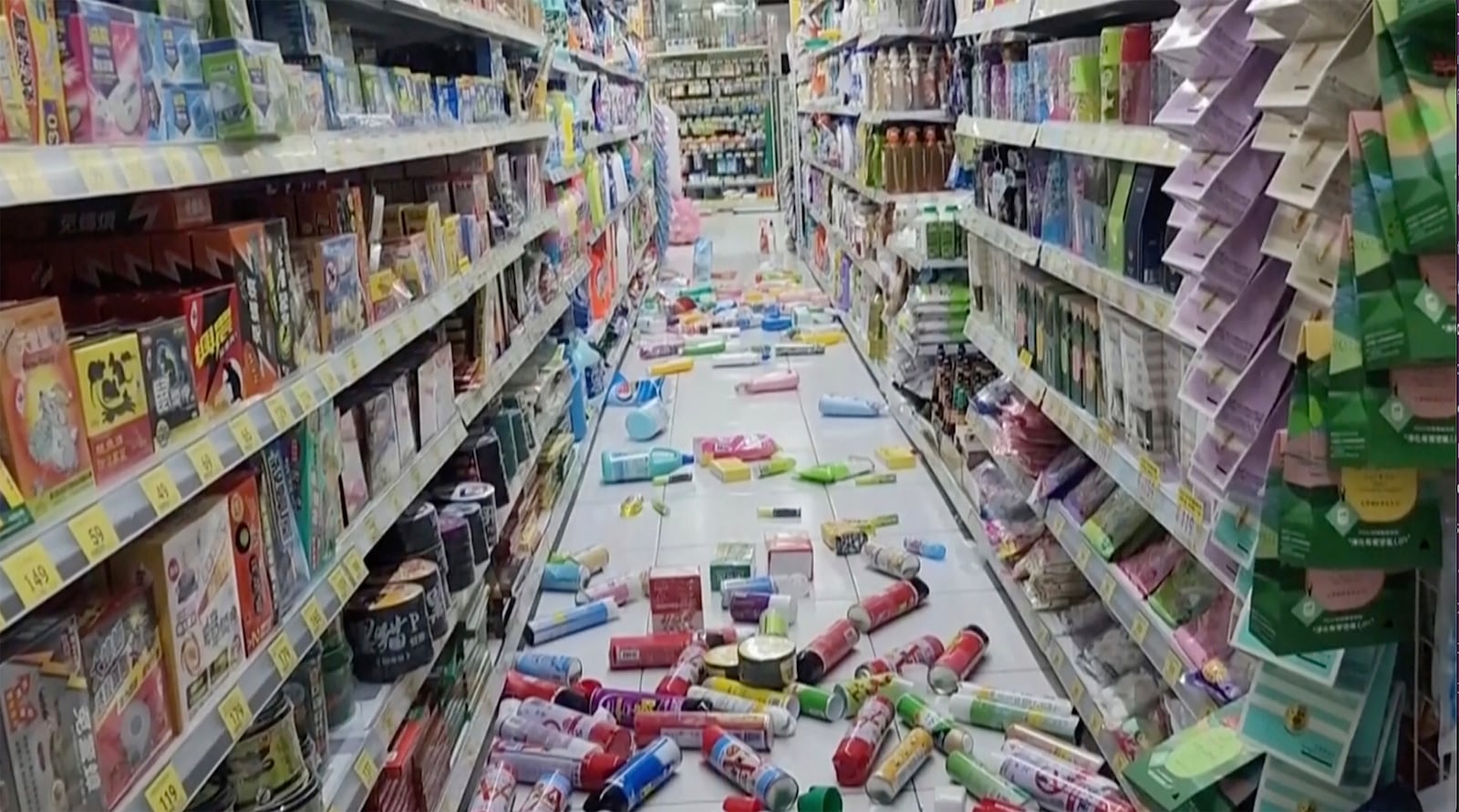 In this image from a video, bottles and cans are scattered on the floor at a convenience store in Tainan, Taiwan Tuesday, Jan. 21, 2025 after an earthquake. (TVBS via AP)