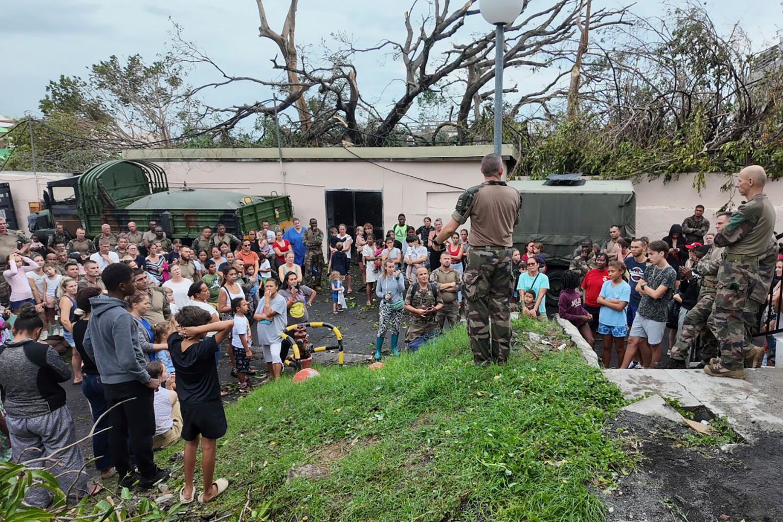 This photo provided Sunday Dec.15, 2024 by the French Army shows soldiers addressing the population in the French territory of Mayotte in the Indian Ocean, after Cyclone Chido caused extensive damage with reports of several fatalities. (Etat Major des Armées via AP)