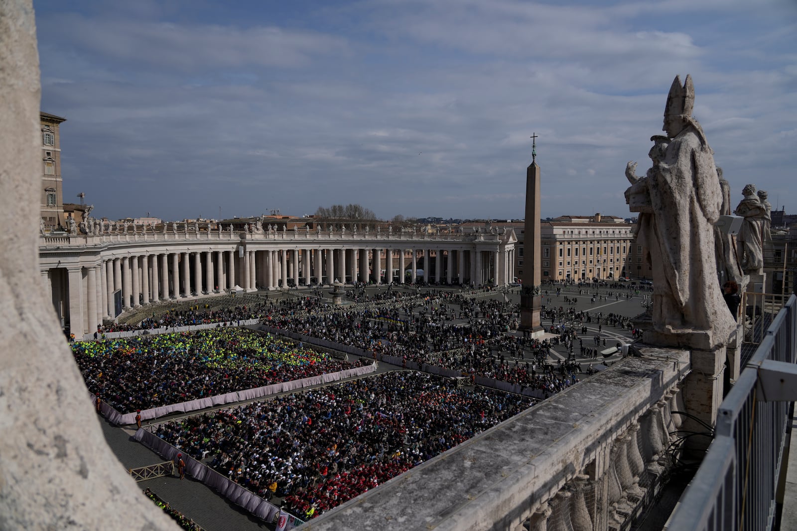 Members of different organizations of volunteers follow Cardinal Michael Czerny, delegate of Pope Francis who is being treated for pneumonia at Rome's Agostino Gemelli Polyclinic, celebrating a mass for the world of volunteers in St. Peter's Square at The Vatican, Sunday, March 9, 2025. (AP Photo/Gregorio Borgia)