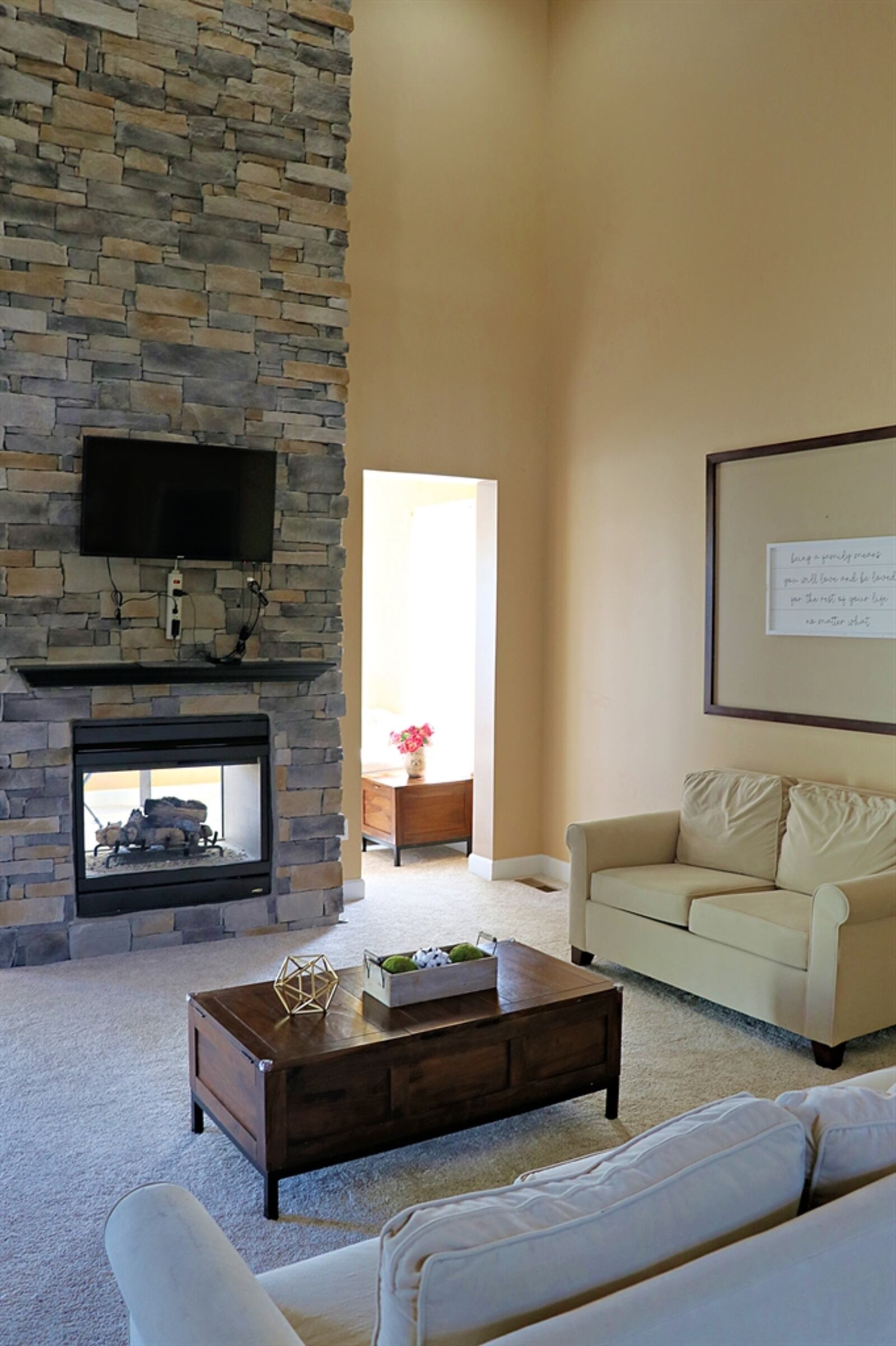 A two-story stone fireplace is the centerpiece to the great room. 