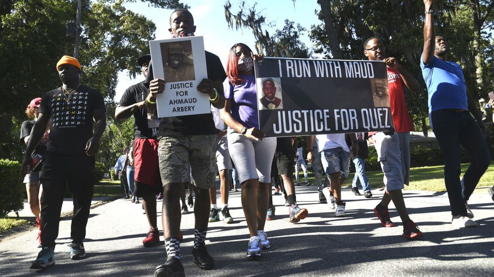 Protesters march Tuesday, May 5, 2020, through the Brunswick, Ga., neighborhood where Ahmaud Arbery, 25, was gunned down as he jogged Feb. 23. The unarmed Arbery, 25, was killed by two white men who believed he was a suspect in a string of recent break-ins. (Bobby Haven/The Brunswick News via AP)