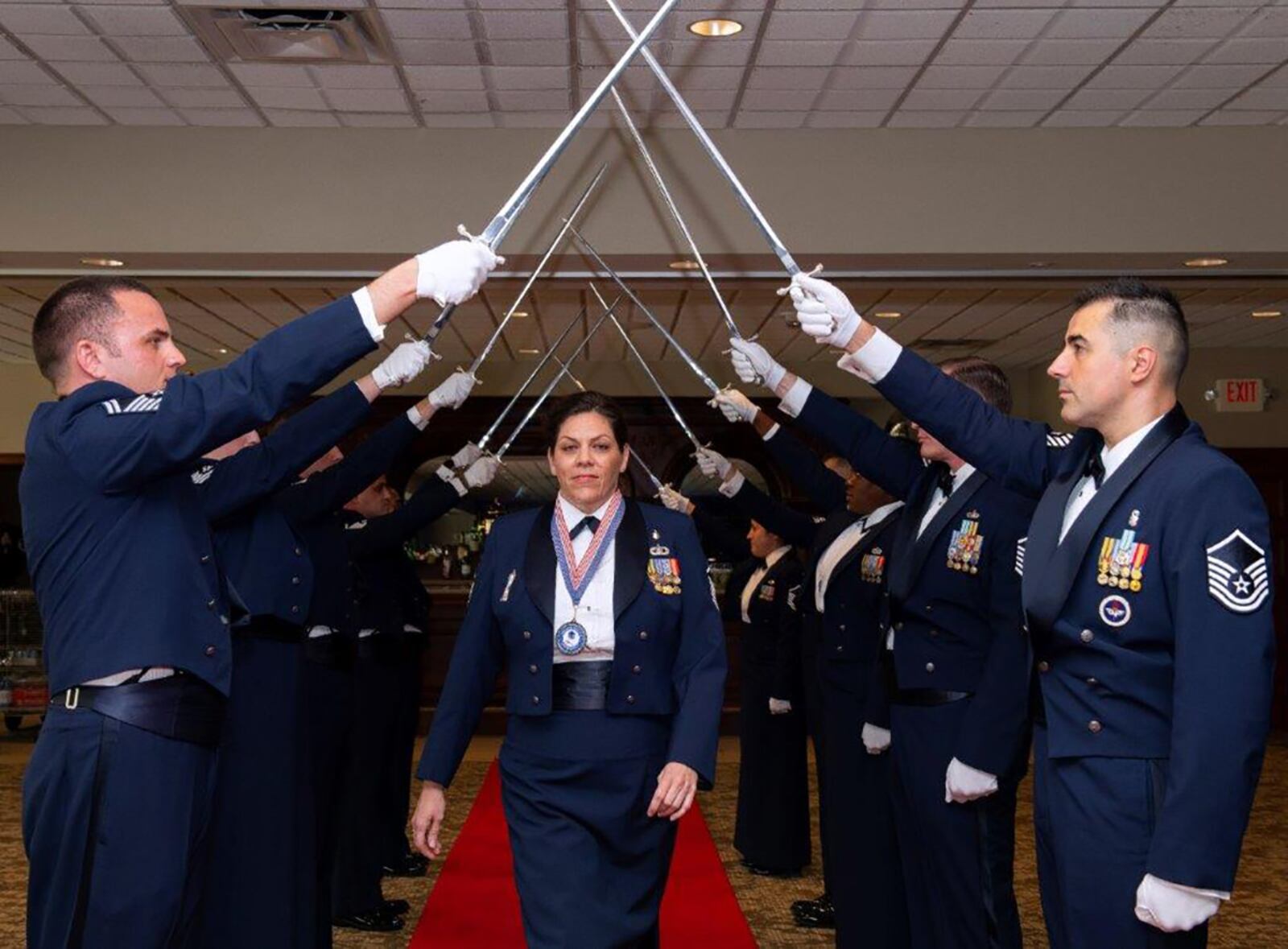 Master Sgt. Danica Bowes, 88th Medical Group, passes through the sword cordon during the start of the senior NCO induction ceremony Aug. 26 at Wright-Patterson Air Force Base. She was among 32 Wright-Patt Airmen welcomed into the senior NCO ranks. U.S. AIR FORCE PHOTO/R.J. ORIEZ