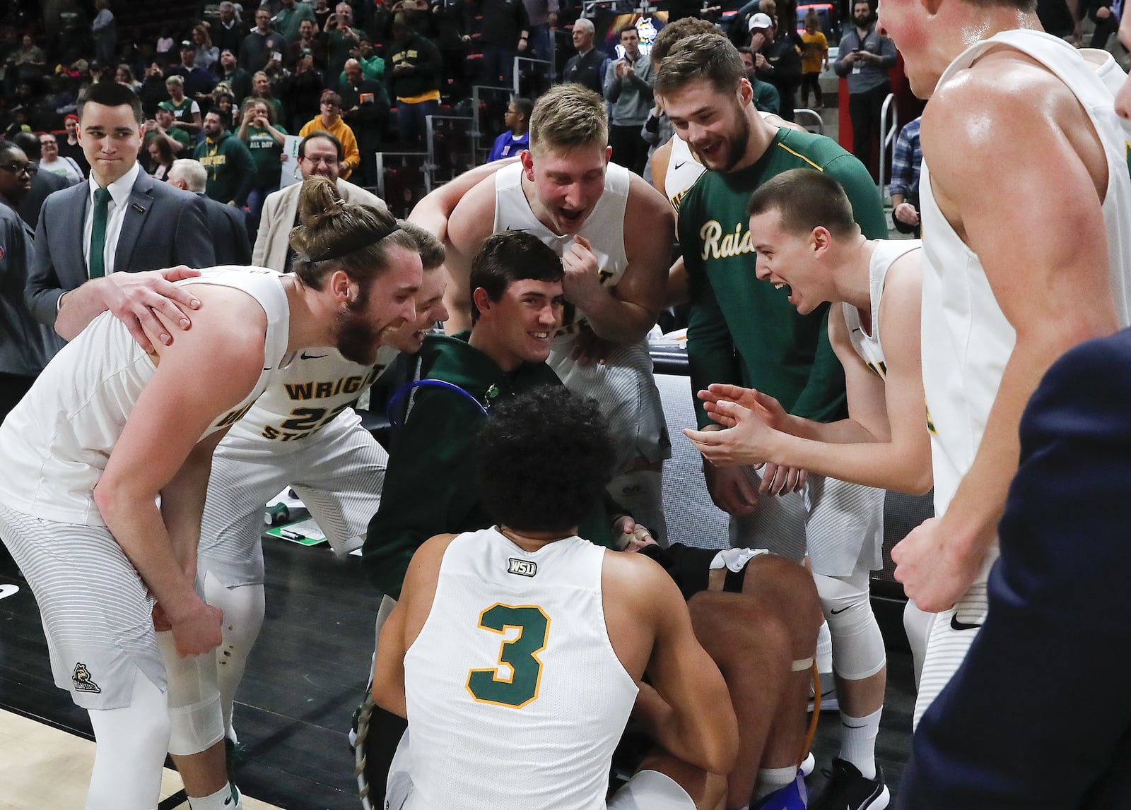 Wright State players celebrate their 74-57 win against Cleveland State with teammate Ryan Custer after an NCAA basketball game in the Horizon League tournament championship in Detroit, Tuesday, March 6, 2018. (AP Photo/Paul Sancya)