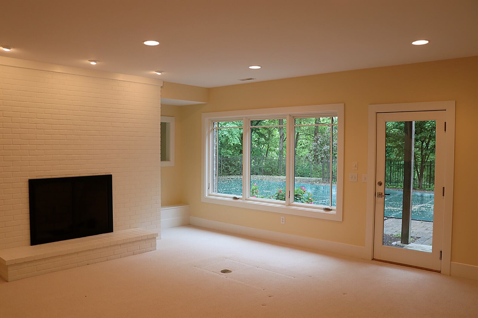 One side of the lower level is the family room with a wood-burning fireplace, built-in bookcases, triple windows and a glass door that opens to the pool deck. The other side is the recreation room with a wet bar tucked into one corner. CONTRIBUTED PHOTO BY KATHY TYLER