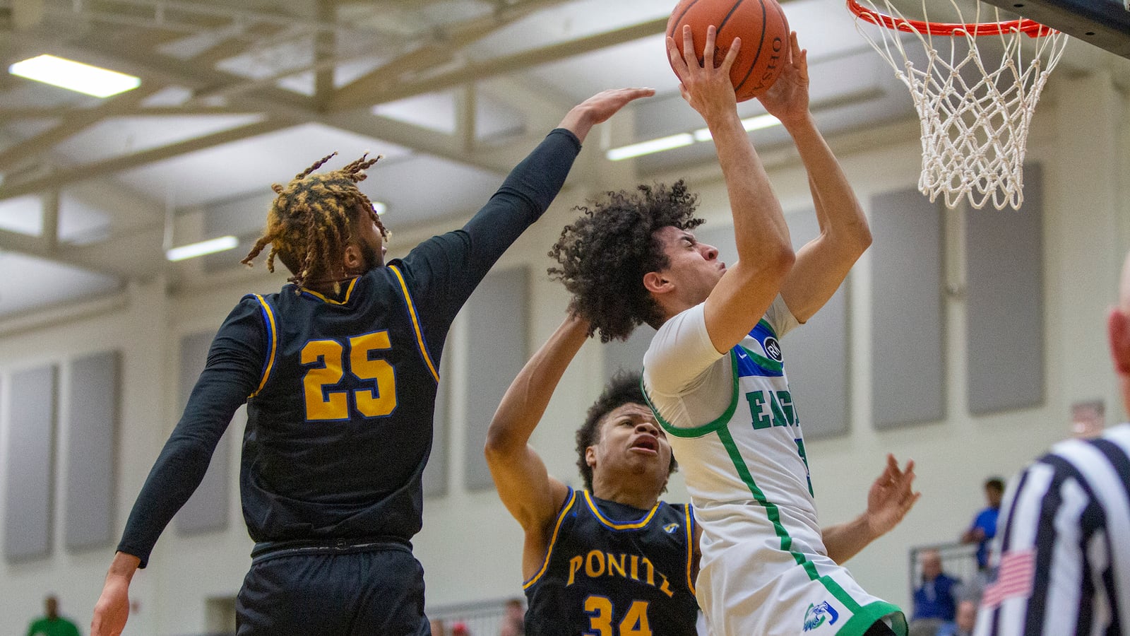 Chaminade Julienne's George Washington III shoots for two of his 30 points in front of Ponitz's Dayjaun Anderson during Friday night's Division II tournament win at Trent Arena. CONTRIBUTED/Jeff Gilbert