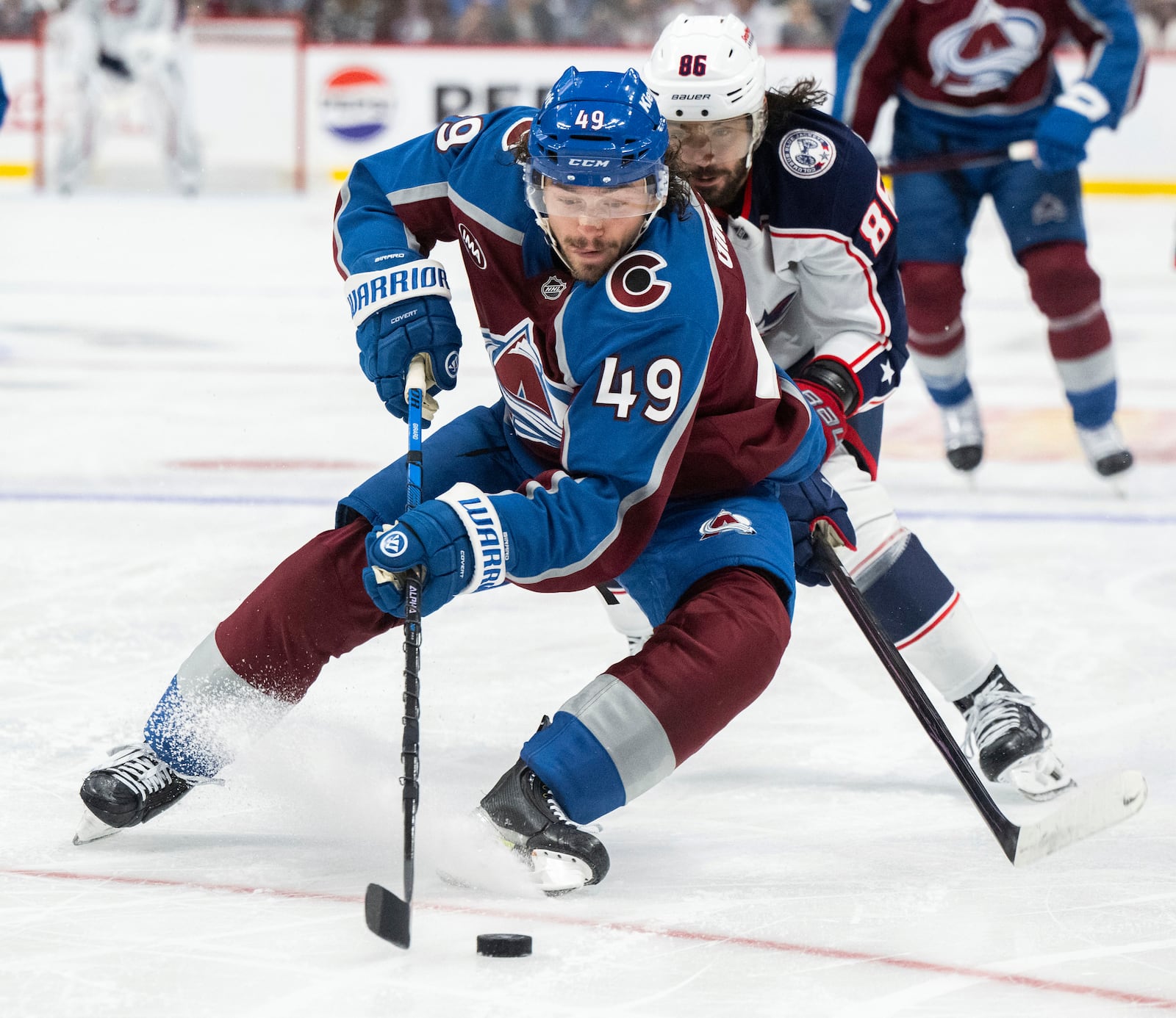 Colorado Avalanche defenseman Samuel Girard (49) fights off Columbus Blue Jackets right wing Kirill Marchenko (86) during the second period of an NHL hockey game, Saturday, Oct. 12, 2024, at Ball Arena in Denver. (Christian Murdock/The Gazette via AP)