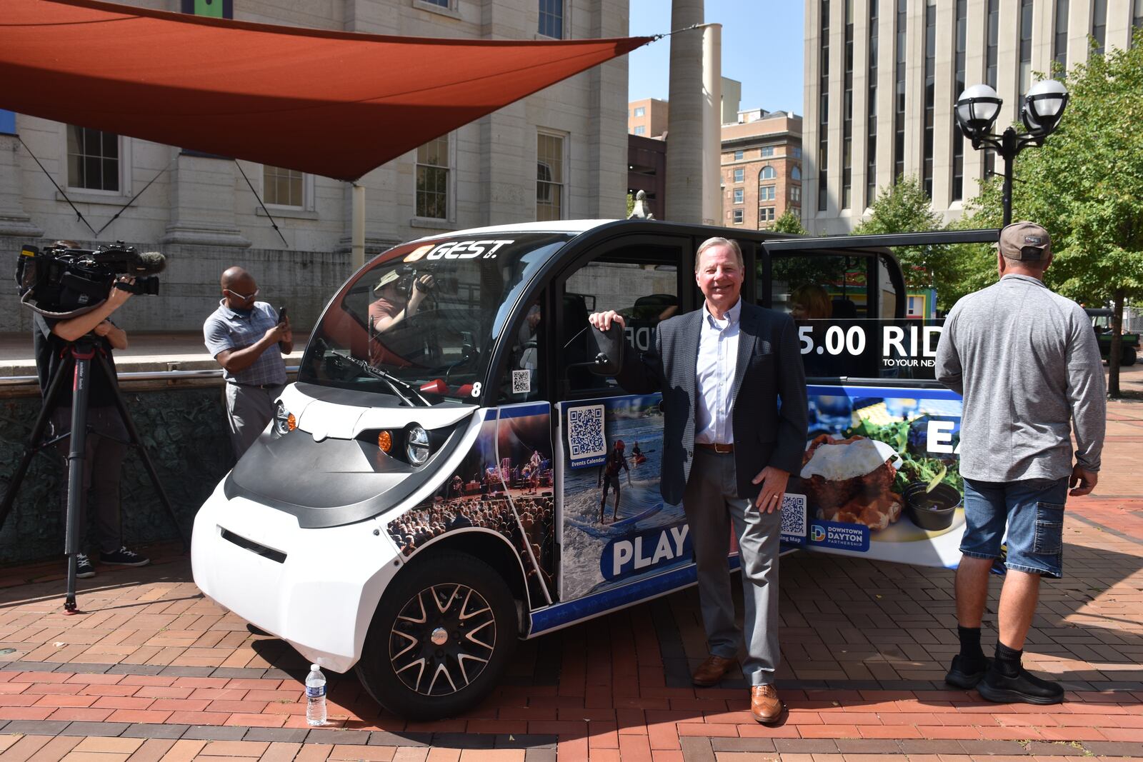 Tom Conroy, owner of GEST Carts Dayton, in front of one of his carts at Courthouse Square during a ribbon-cutting ceremony for the new service on Friday, Aug. 23, 2024. CORNELIUS FROLIK / STAFF