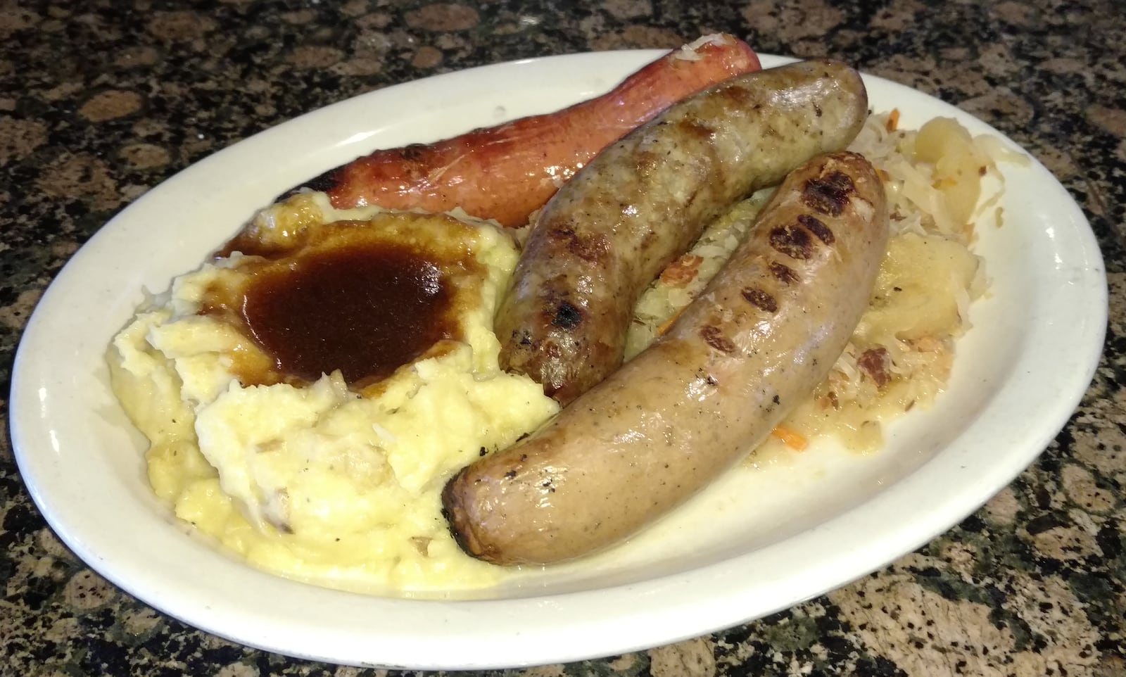 Amber Rose's Three Sausage Sampler includes beer braised knockwurst, bratwurst and Polish sausage. It is served with house made sauerkraut and smashed Yukon gold Potatoes for $16