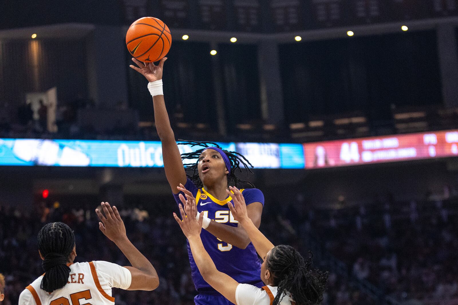 LSU forward Sa'Myah Smith, center, shoots over Texas forward Madison Booker, left, and guard Jordan Lee during the first half of an NCAA college basketball game in Austin, Texas, Sunday, Feb. 16, 2025. (AP Photo/Stephen Spillman)