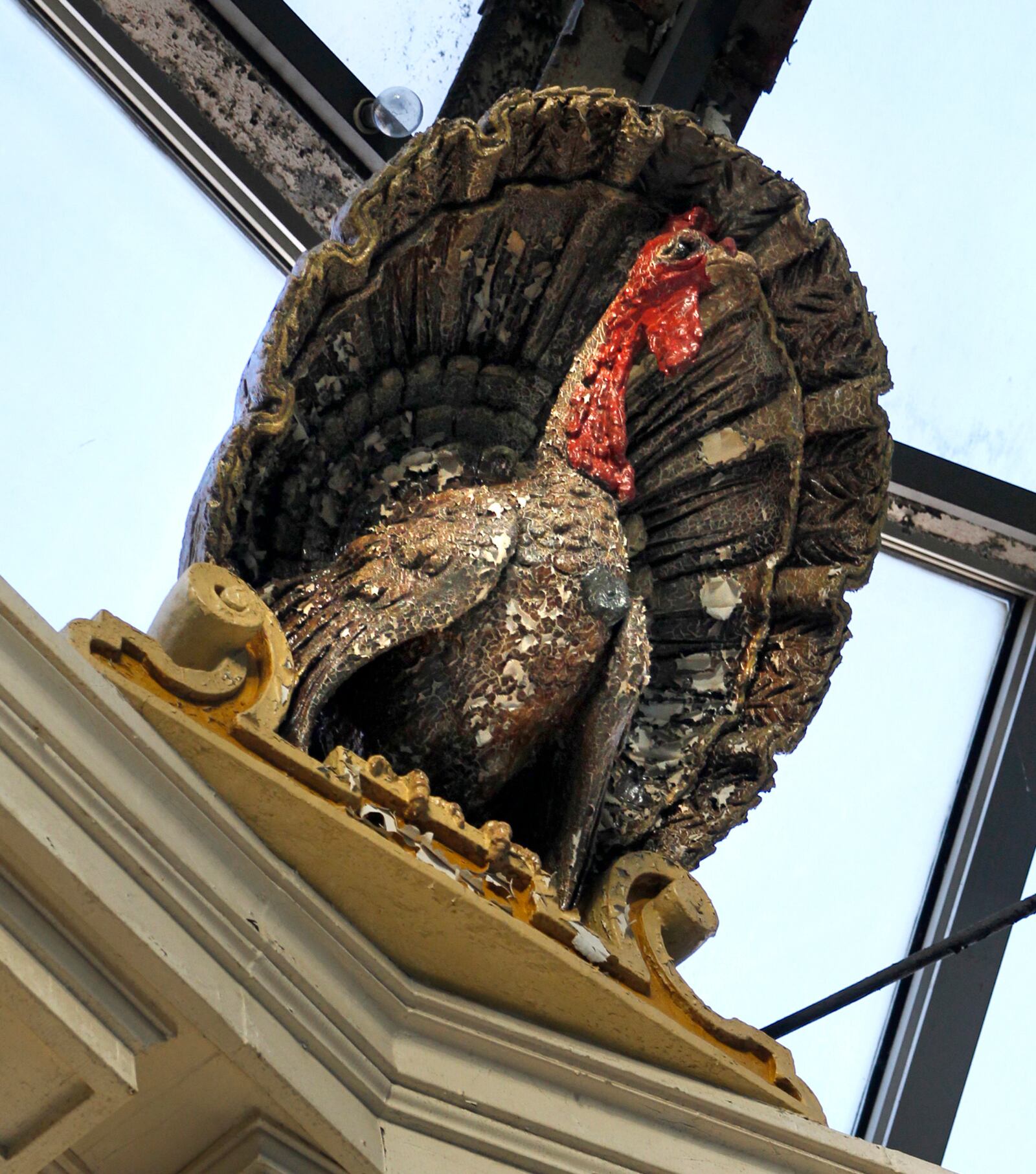 Colorful turkeys with crested tails are crafted from sheet metal and surround the top of the glass domed rotunda.  LISA POWELL / STAFF