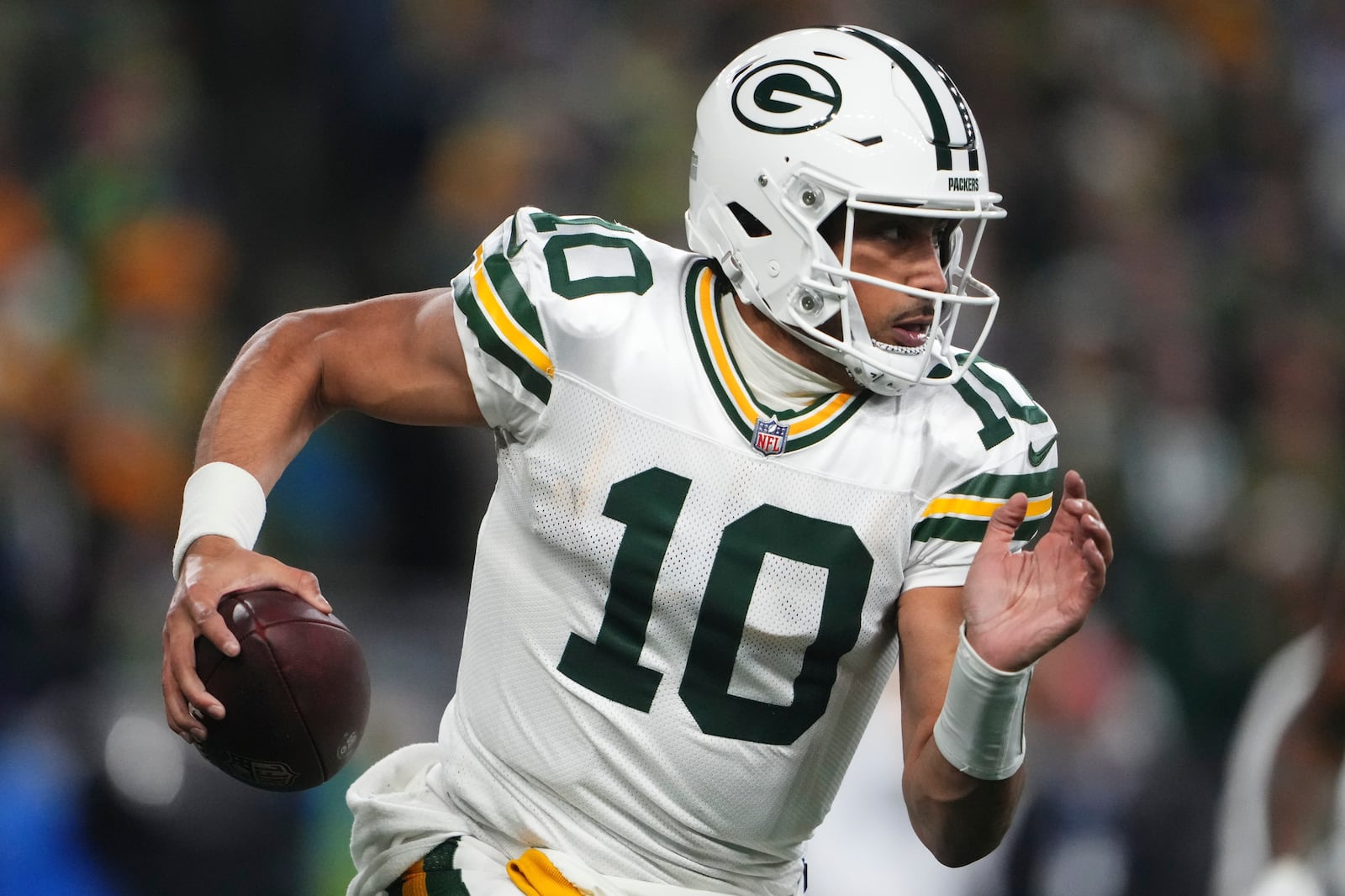 Green Bay Packers' Jordan Love runs during the second half of an NFL football game against the Seattle Seahawks Sunday, Dec. 15, 2024, in Seattle. (AP Photo/Lindsey Wasson)