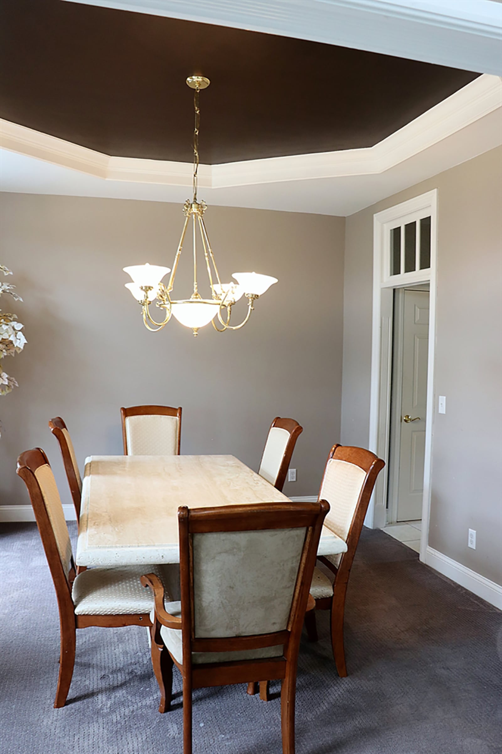 To the left of the main entry, a walkway with transom window leads into the formal dining room with a tray ceiling. CONTRIBUTED PHOTO BY KATHY TYLER