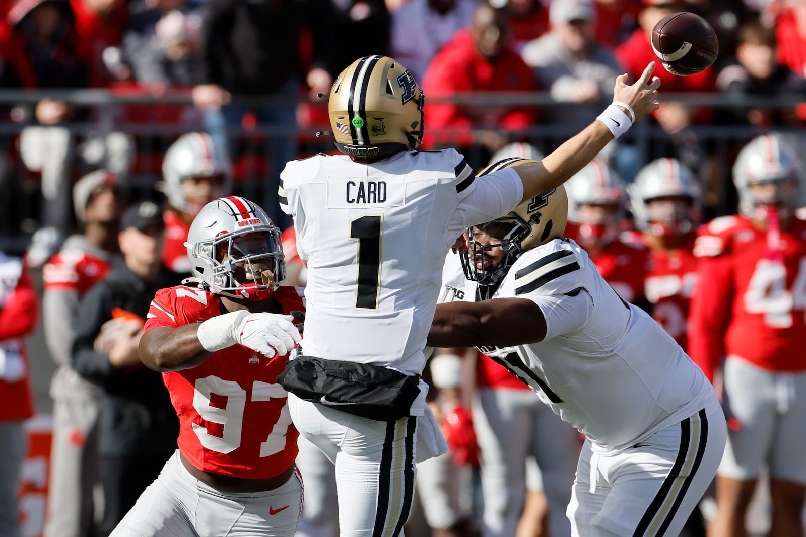 Purdue quarterback Hudson Card, front, throws a pass as teammate offensive lineman Corey Stewart, right, tries to block Ohio State defensive lineman Kenyatta Jackson during the first half of an NCAA college football game Saturday, Nov. 9, 2024, in Columbus, Ohio. (AP Photo/Jay LaPrete)