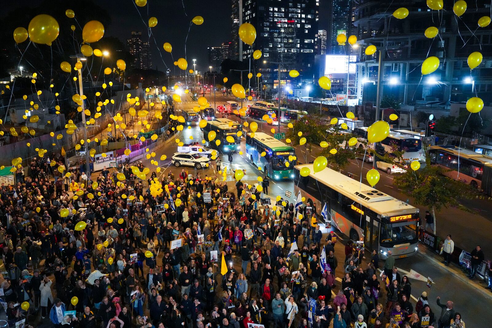 Relatives and supporters of Israelis held hostage by Hamas in Gaza release balloons to mark the 500 days of captivity and demand their release in Tel Aviv, Israel, on Monday, Feb. 17, 2025. (AP Photo/Ariel Schalit)