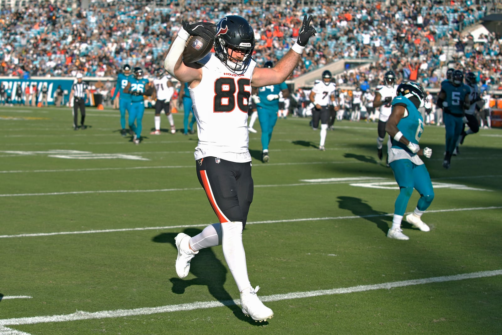 Houston Texans tight end Dalton Schultz (86) celebrates as he scores against the Jacksonville Jaguars on a 22-yard reception during the second half of an NFL football game Sunday, Dec. 1, 2024, in Jacksonville, Fla. (AP Photo/John Raoux)