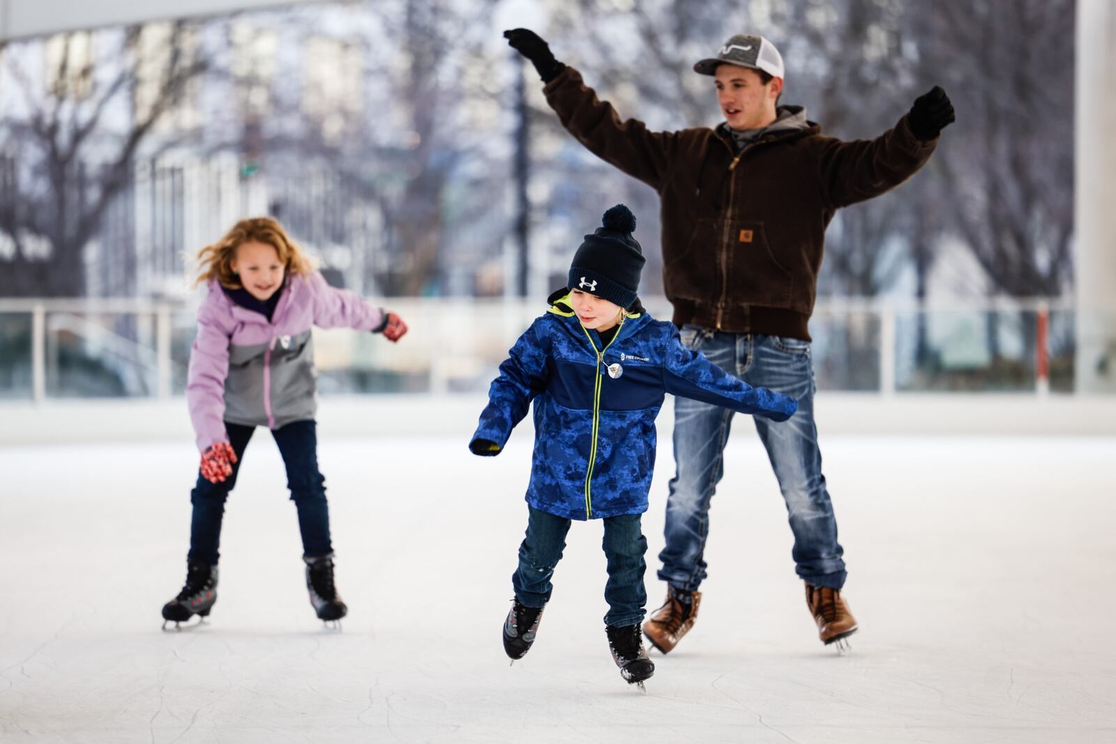 From left, Alyson Spencer, Clint Spencer and Chase Fox enjoy the warm weather at RiverScape in Dayton. Jim Noelker/Staff 