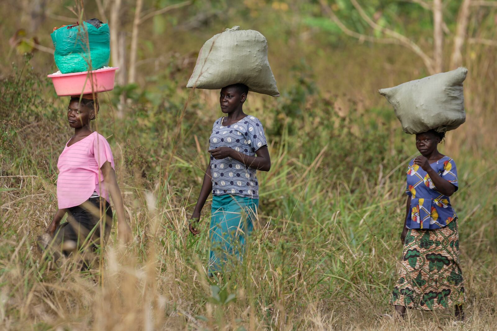 Women walk to the market near Nzara, South Sudan on Saturday, Feb. 15, 2025. (AP Photo/Brian Inganga)