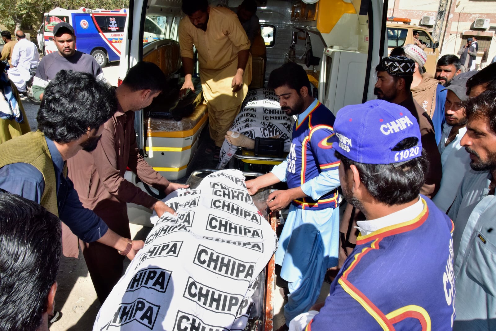 Volunteers and relatives load bodies of victims of a bomb explosion at railway station, into an ambulance after receiving from a hospital, in Quetta, southwestern Pakistan, Saturday, Nov. 9, 2024. (AP Photo/Arshad Butt)