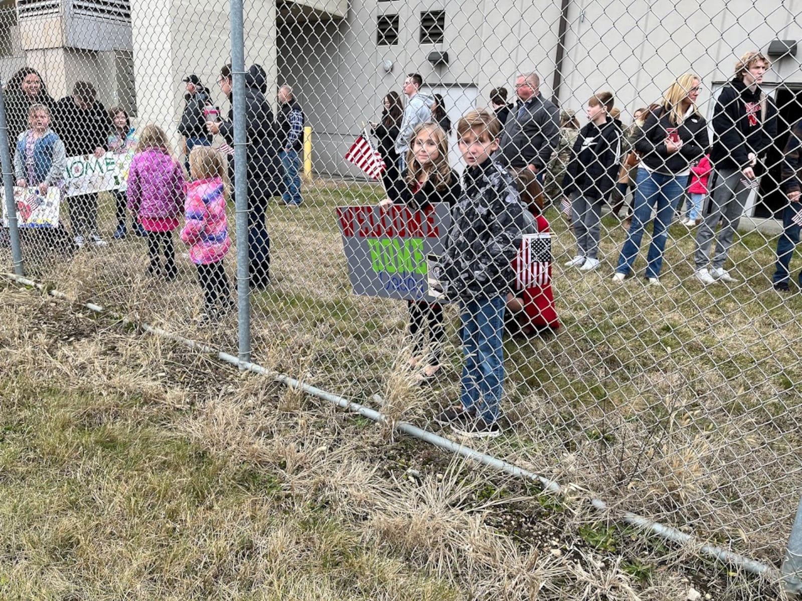 Families ready to greet returning Airmen of the 445th Airlift Wing at Wright-Patterson Air Force Base Thursday. THOMAS GNAU/STAFF