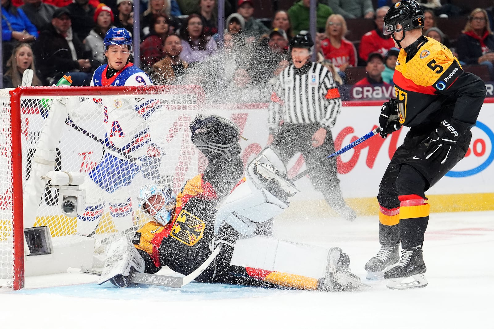 Germany goaltender Nico Pertuch (1) makes a save during first period IIHF World Junior Hockey Championship preliminary round action against the United States, in Ottawa on Thursday, Dec. 26, 2024. (Sean Kilpatrick/The Canadian Press via AP)