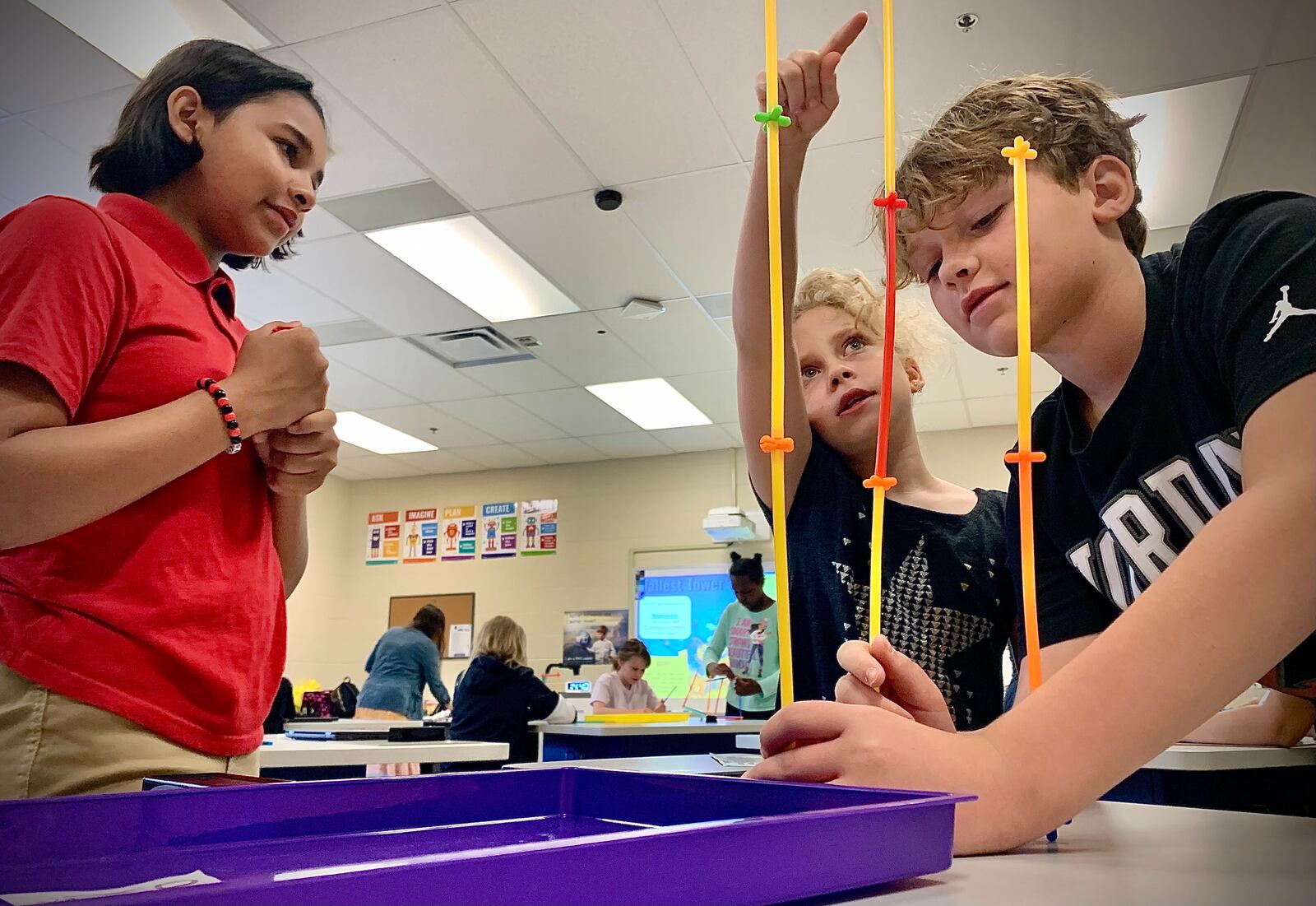 Kinder Elementary fourth grade students, from left, Liah Santiagc, Phoebe Turull and Lawson Throckm work on a project Wednesday, May 15, 2024 in the classroom of STEAM teacher Jessica Lay. MARSHALL GORBY\STAFF