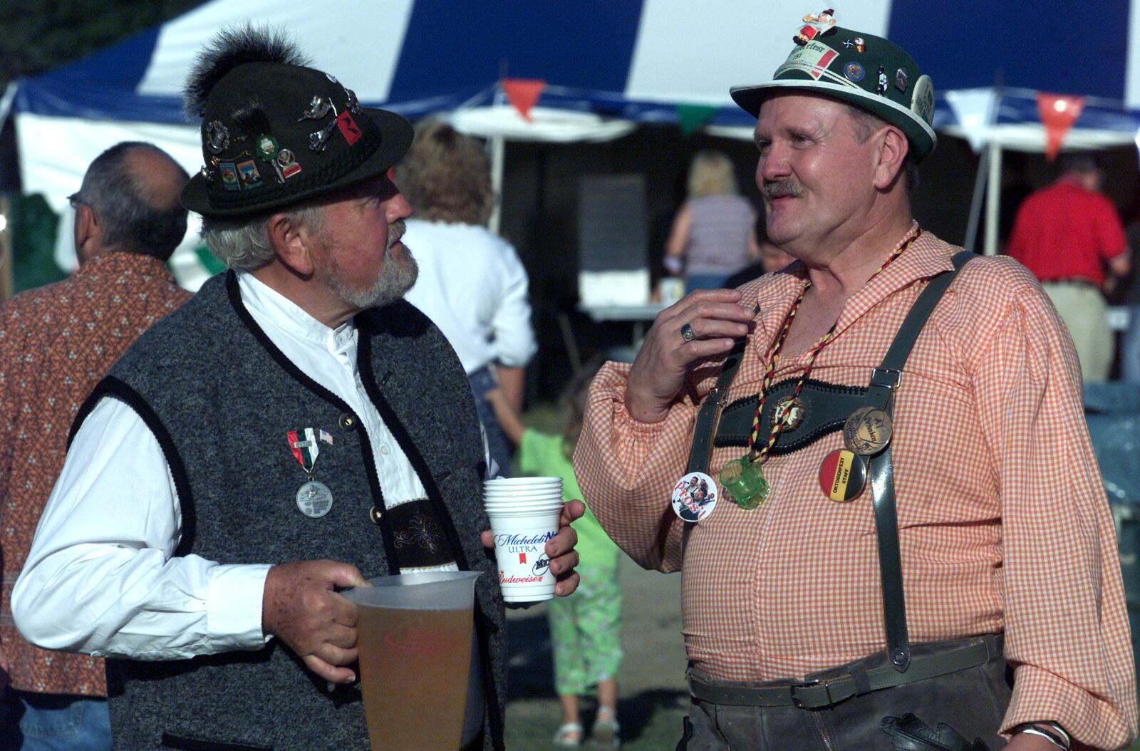 9/6/02   John Wagenbach (left), of Phillipsburg, and Al Behnken, of Dayton, enjoyed the sunny weather in their traditional German costumes on Saturday, at the 27th Annual Oktoberfest in Vandalia.