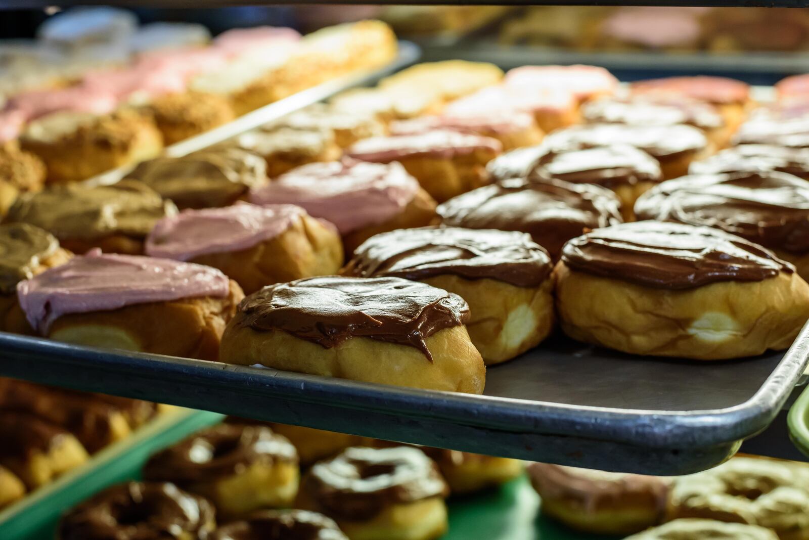 Happy National Donut Day! Here's a look behind-the-scenes of the donut making process at Bear Creek Donuts in Miamisburg and The Donut Haus Bakery in Springboro. Top sellers at Bear Creek Donuts are apple fritters and yeast rings (sprinkled with Oreo, Fruity Pebbles or maple bacon). Apple fritters and sour cream donuts are the top sellers at The Donut Haus Bakery. National Donut Day was started in 1938 by the Salvation Army to honor their Salvation Army Donut Lassies aka Donut Girls, volunteers who made fresh donuts during World War I for American soldiers serving in France. TOM GILLIAM / CONTRIBUTING PHOTOGRAPHER