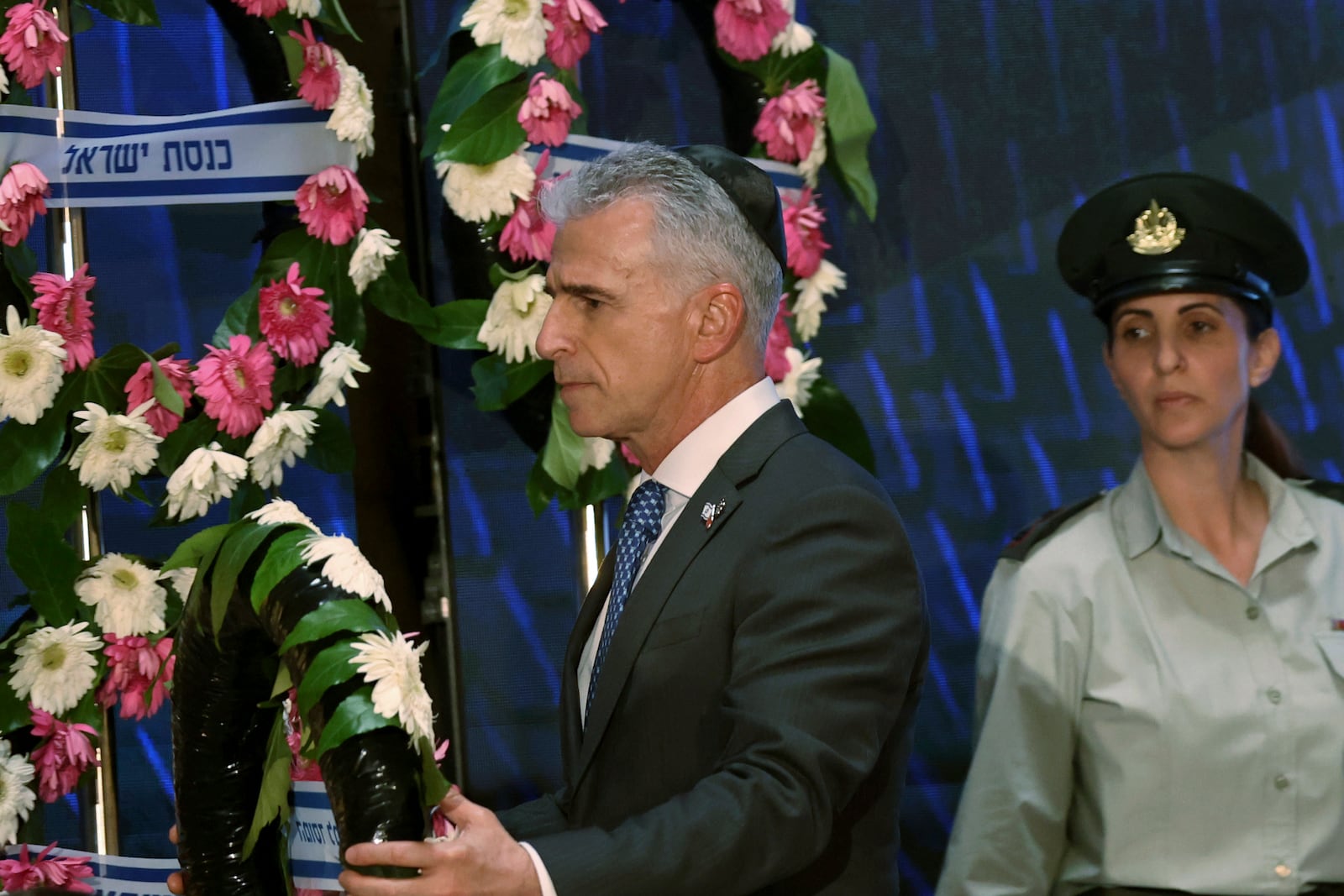 FILE - Mossad intelligence agency chief David Barnea lays a wreath during a ceremony marking Memorial Day for fallen soldiers of Israel's wars and victims of attacks at Jerusalem's Mount Herzl military cemetery, May 13, 2024. (Gil Cohen-Magen/Pool Photo via AP, File)