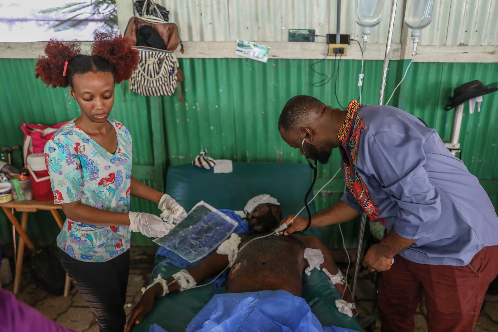 Doctors treat a man shot and wounded during armed gang attacks at Saint Nicolas hospital in Saint-Marc, Haiti, Sunday, Oct. 6, 2024. (AP Photo/Odelyn Joseph)