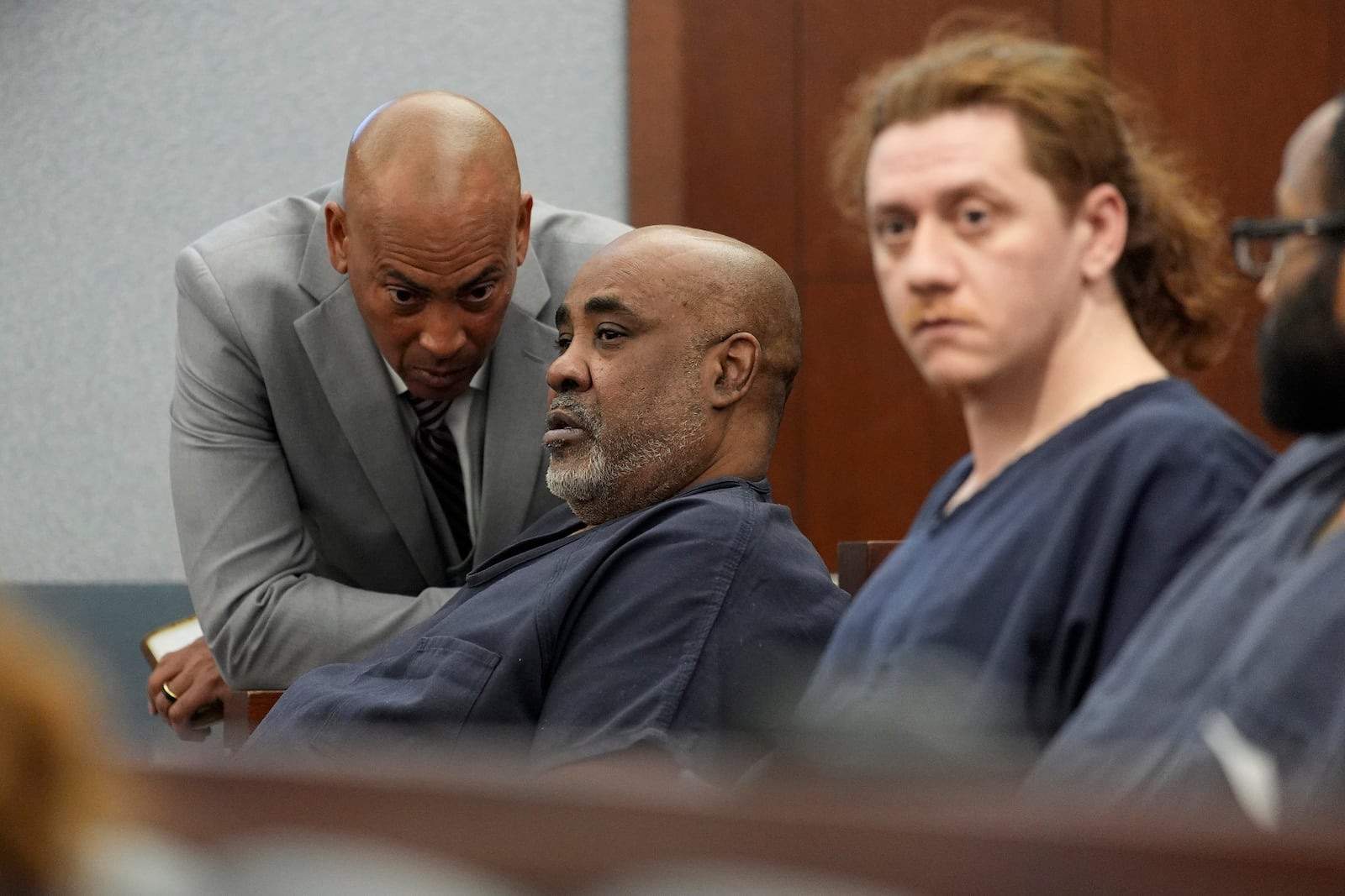 Duane "Keffe D" Davis, second from left, speaks with attorney Carl E.G. Arnold during a court appearance in District Court for his involvement in the 1996 killing of rapper Tupac Shakur Tuesday, Feb. 18, 2025, in Las Vegas. (AP Photo/John Locher, Pool)