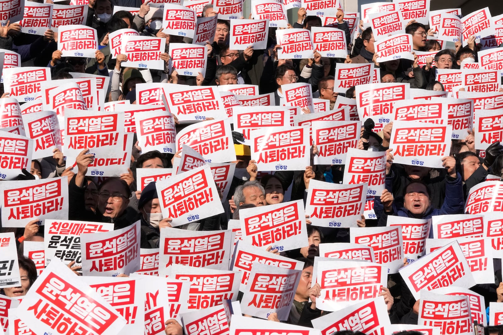 Members of main opposition Democratic Party stage a rally against South Korean President Yoon Suk Yeol at the National Assembly in Seoul, South Korea, Wednesday, Dec. 4, 2024. The signs read "Yoon Suk Yeol should resign." (AP Photo/Ahn Young-joon)