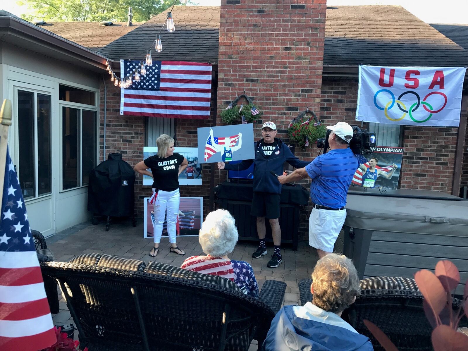 Mark Murphy addresses the friends, neighbors and relatives who gathered at his Piqua home early Wednesday morning for an Olympics Watch Party as his son Clayton, a Tri- Village High grad and bronze medalist in the 2016 Olympics, ran in the 800-meter final in Tokyo. Boxed in early, Clayton finished. last of nine runners after posting some of the fastest times in the preliminary heat and semi-final races. Photo by Tom Archdeacon