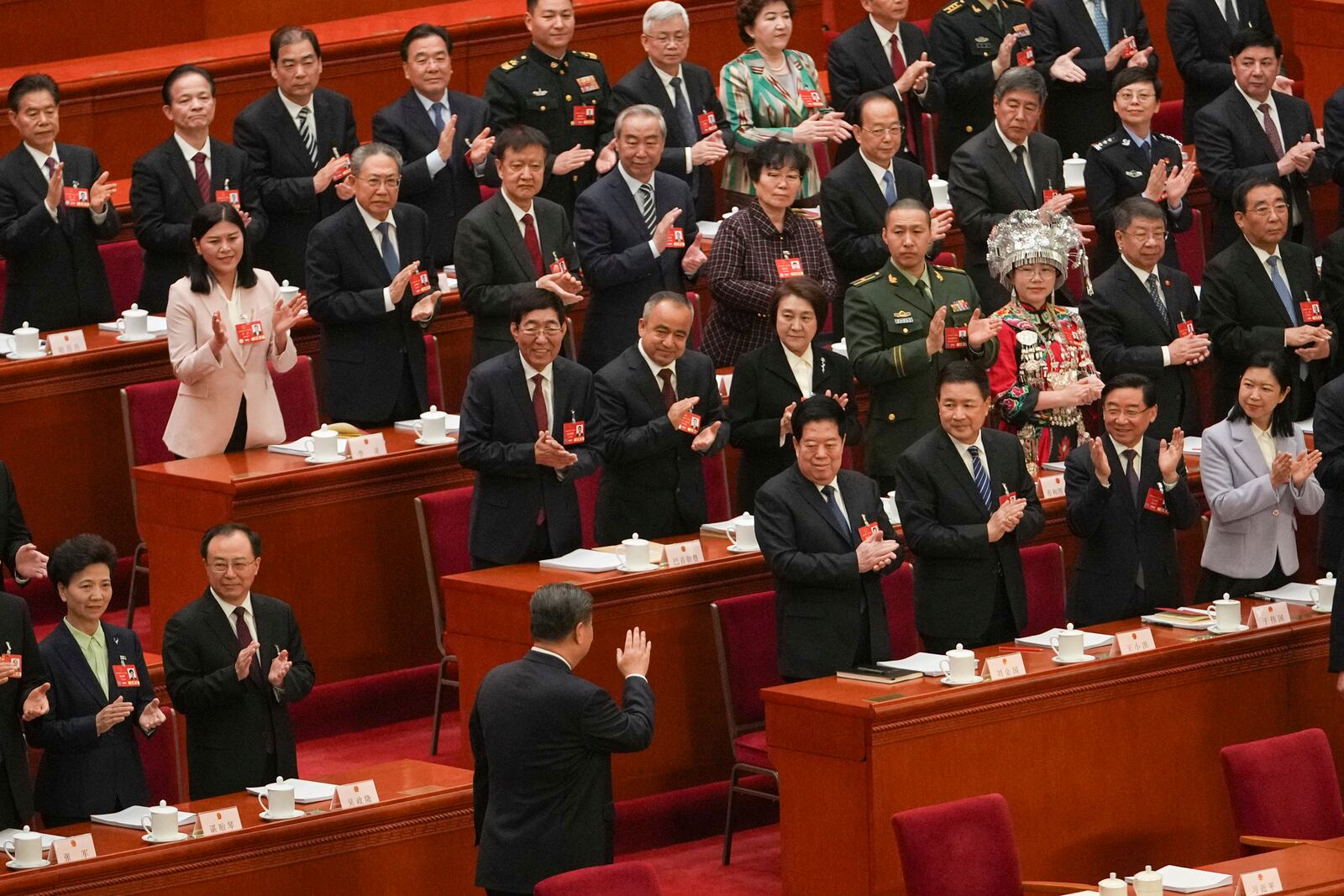 Chinese President Xi Jinping gestures to delegates during the opening session of the National People's Congress (NPC) at the Great Hall of the People in Beijing, China, Wednesday, March 5, 2025. (AP Photo/Andy Wong)