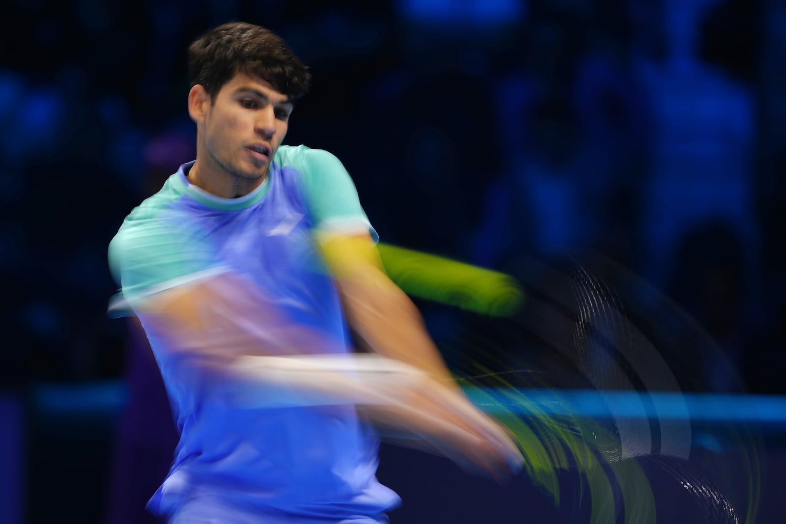 Spain's Carlos Alcaraz returns the ball to Denmark's Casper Ruud during their singles tennis match of the ATP World Tour Finals at the Inalpi Arena, in Turin, Italy, Monday, Nov. 11, 2024. (AP Photo/Antonio Calanni)