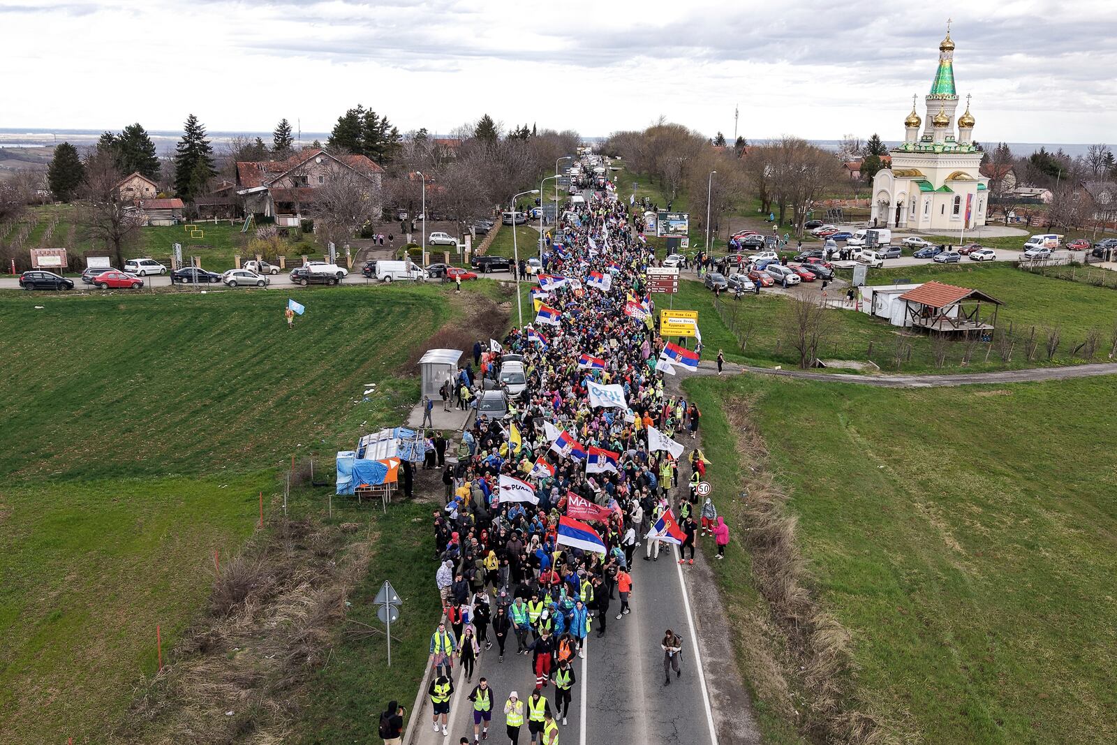 An aerial view of students and anti-government protesters marching towards Belgrade for a joint protest after taking a break in Cortanovci, Serbia, Thursday, March 13, 2025. (AP Photo/Armin Durgut)