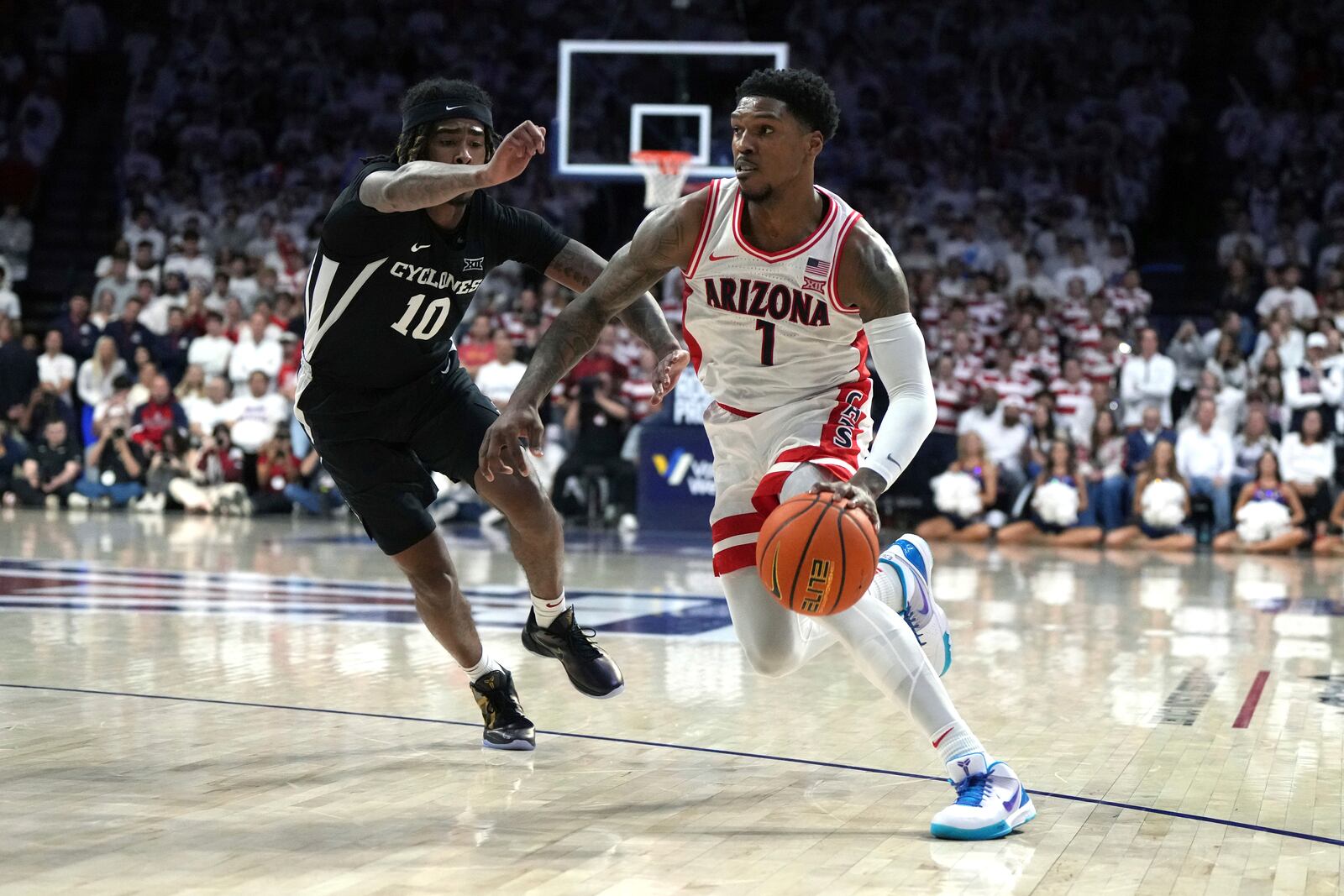 Arizona guard Caleb Love drives on Iowa State guard Keshon Gilbert (10) during the second half of an NCAA college basketball game, Monday, Jan. 27, 2025, in Tucson, Ariz. (AP Photo/Rick Scuteri)