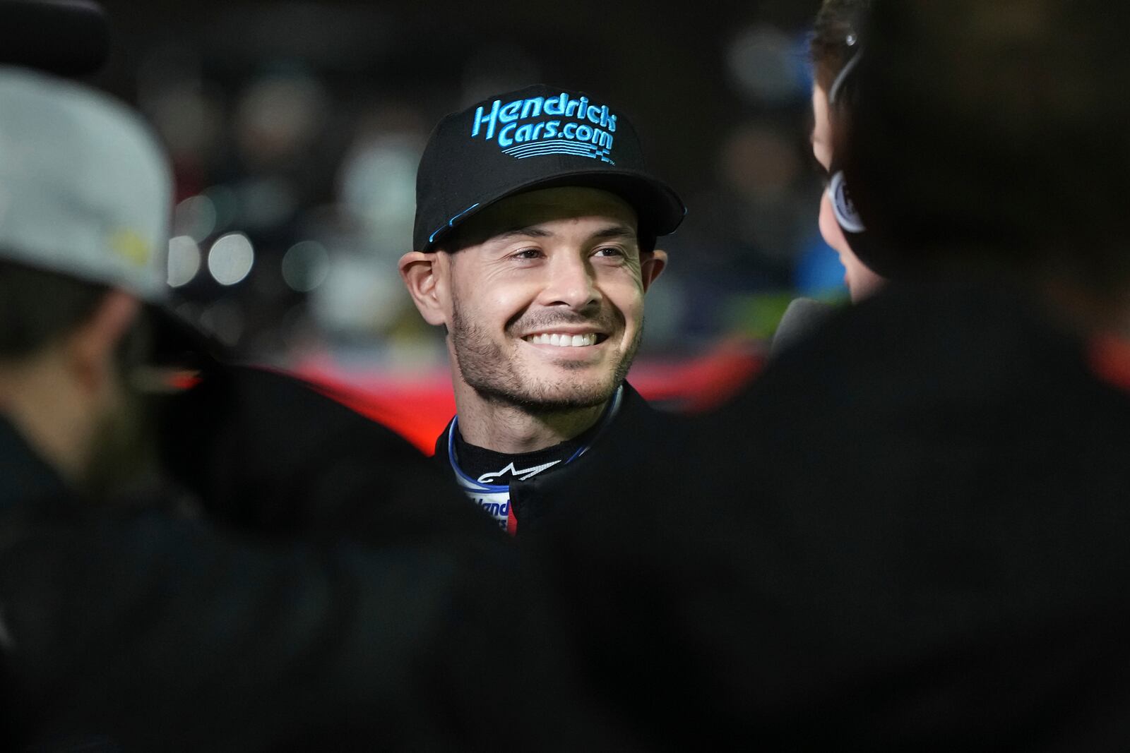 Kyle Larson smiles prior to a qualifying heat for a NASCAR Cup Series auto race at Bowman Gray Stadium, Sunday, Feb. 2, 2025, in Winston-Salem, N.C. (AP Photo/Matt Kelley)