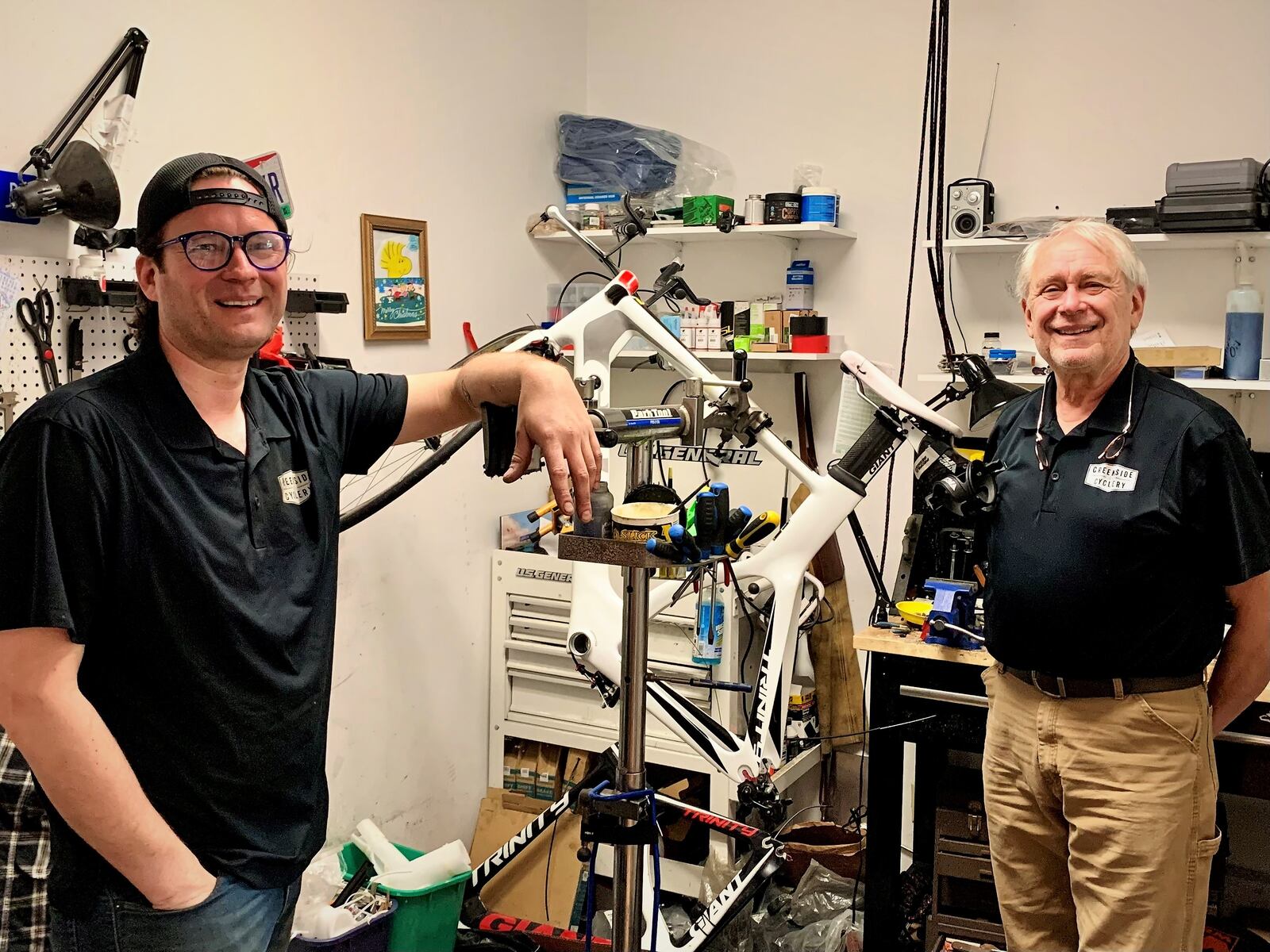 Conrad and Mike Dillon work on a bicycle in their small shop on North Fairfield Road in Beavercreek. The pair plan to build a new location that's almost three times the size of their current location.