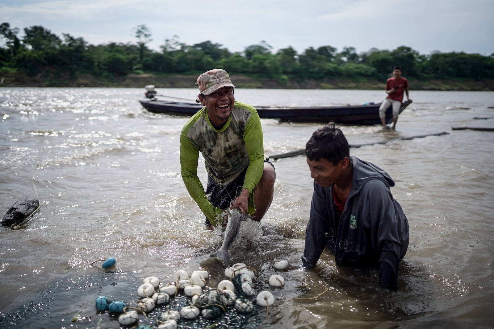 Men from the Cocama Indigenous community fish in the Amazon River amid a drought on the outskirts of Leticia, Colombia, Monday, Oct. 21, 2024. (AP Photo/Ivan Valencia)