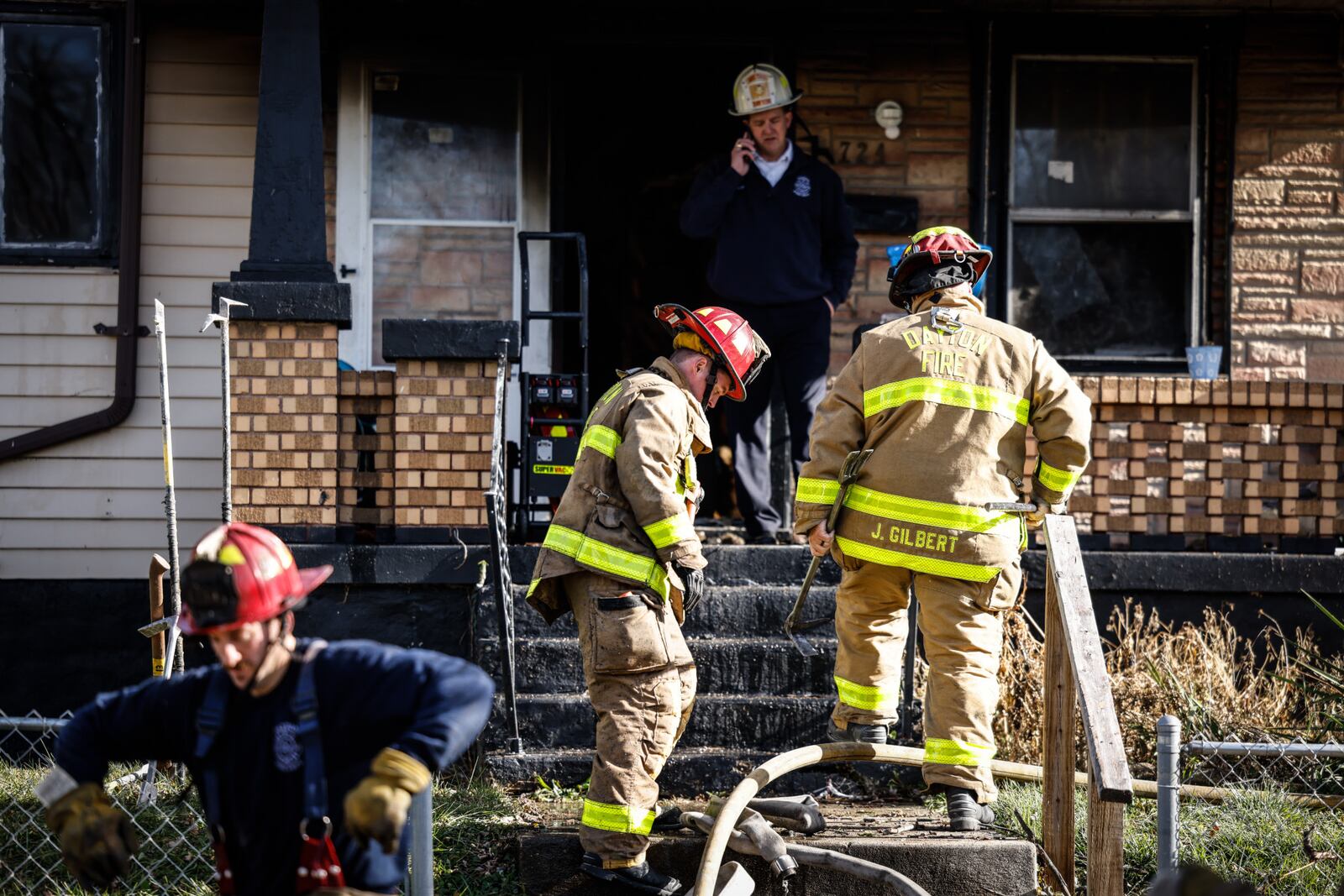 Two Dayton firefighters sustained burn injuries while battling a house fire on Crestmore Avenue. JIM NOELKER/STAFF