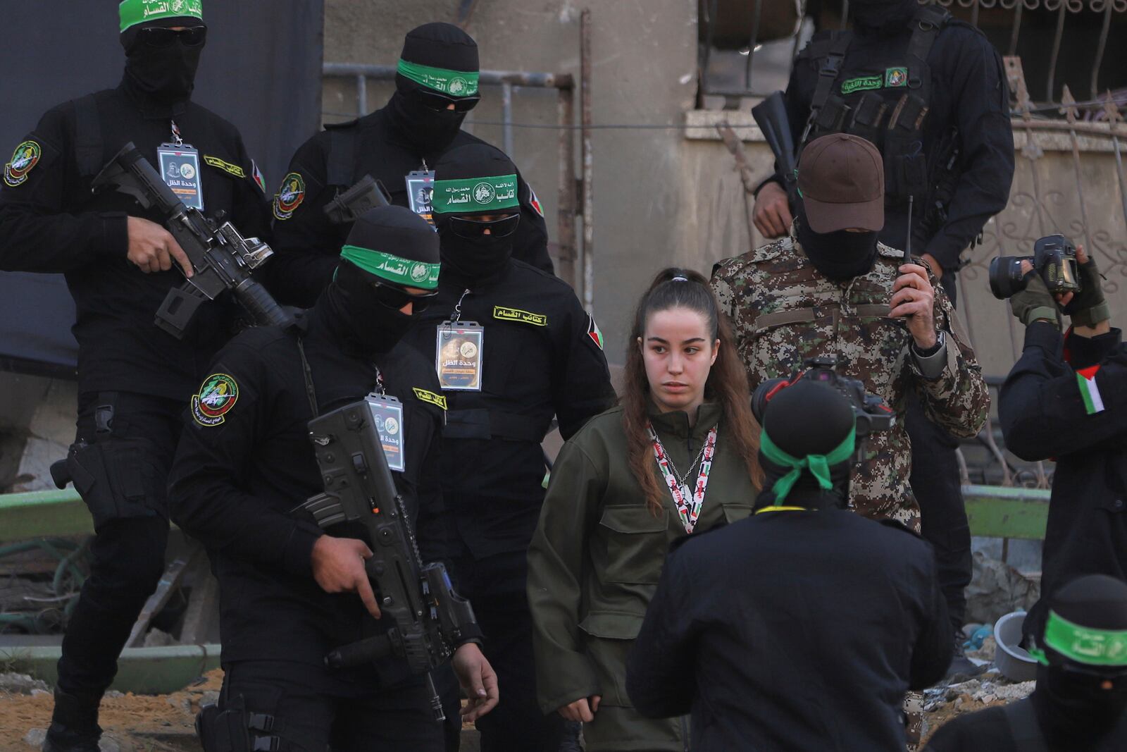 Israeli soldier Agam Beger walks next to masked Islamic Jihad militants as she is handed over to the Red Cross at the Jabalya refugee camp in Gaza City, Thursday Jan. 30, 2025.(AP Photo/Mohammed Hajjar)