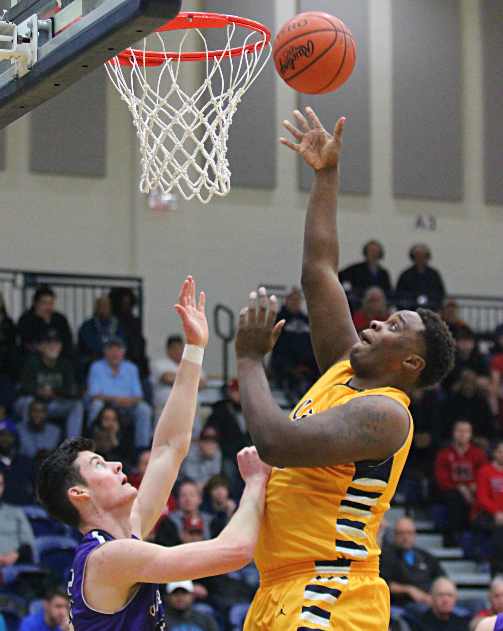 Springfield’s Darius Harper lays in a shot during the Flyin’ to the Hoop invitational on Sunday. Springfield lost to Massillon Jackson 73-54. GREG BILLING / STAFF